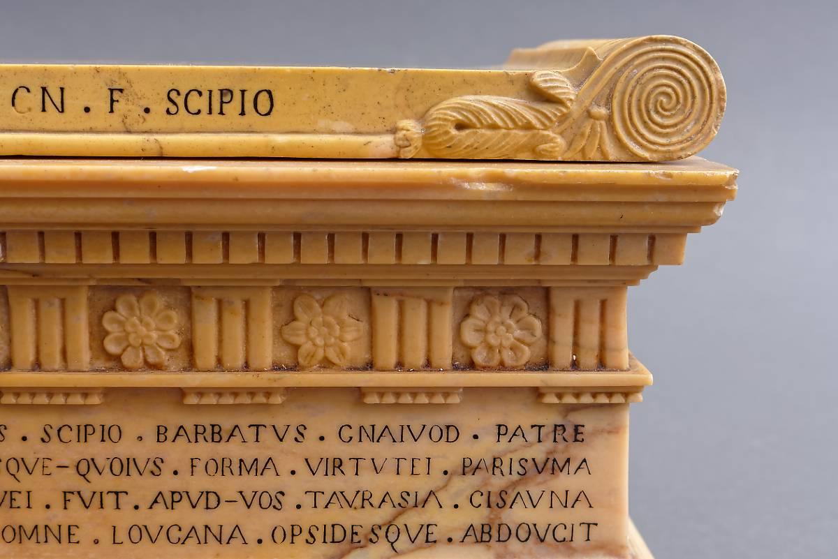 An Italian Grand Tour early 19th century Siena marble model of a sarcophagus from the tomb of the Scipios, after the antique. The sarcophagus of rectangular form in carved solid Siena marble, the lid with acanthus-scrolled ends, the front edge