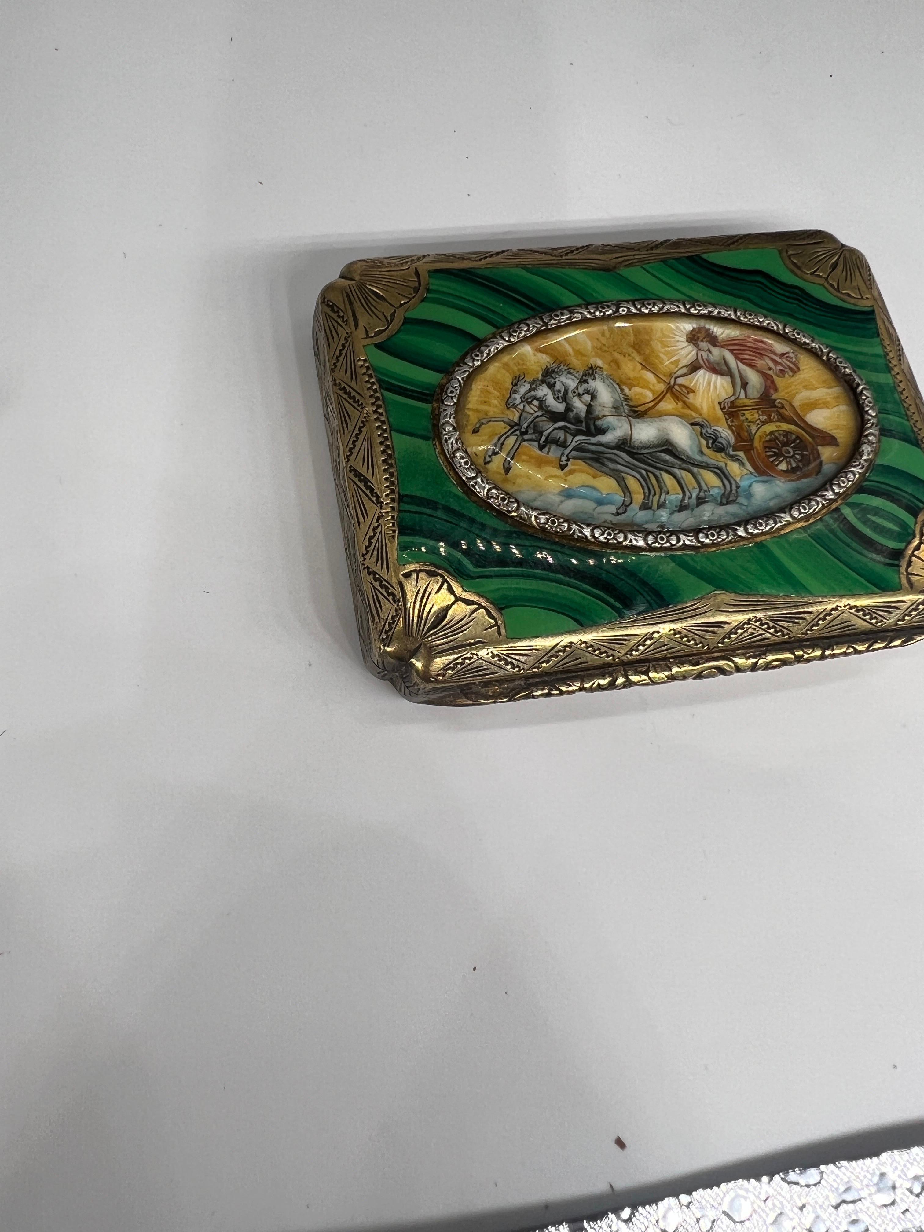 Italian Grand Tour 800 Silver, Enameled Malachite & Painted Roman Scene Box.

This fantastic antique box is rectangular in form heavily decorated with hand chased foliate scroll work, fan form corners accenting the hand enameled faux malachite
