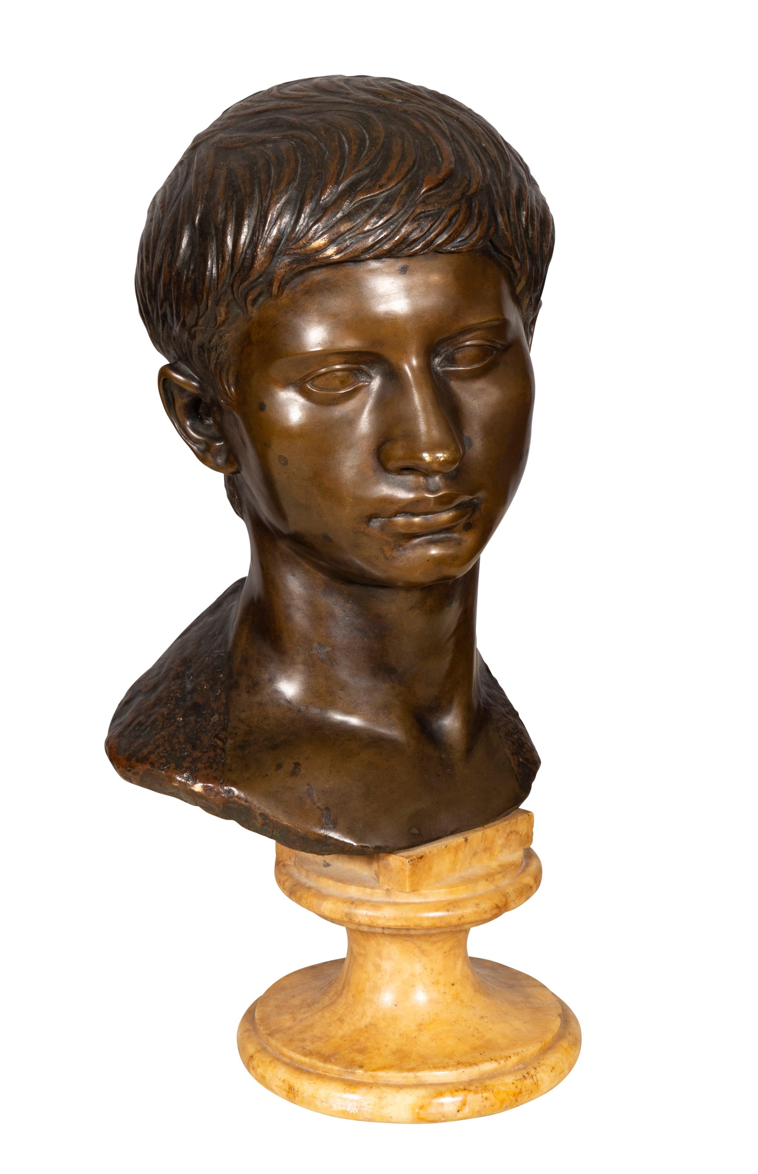 Bronze bust on yellow marble socle.
