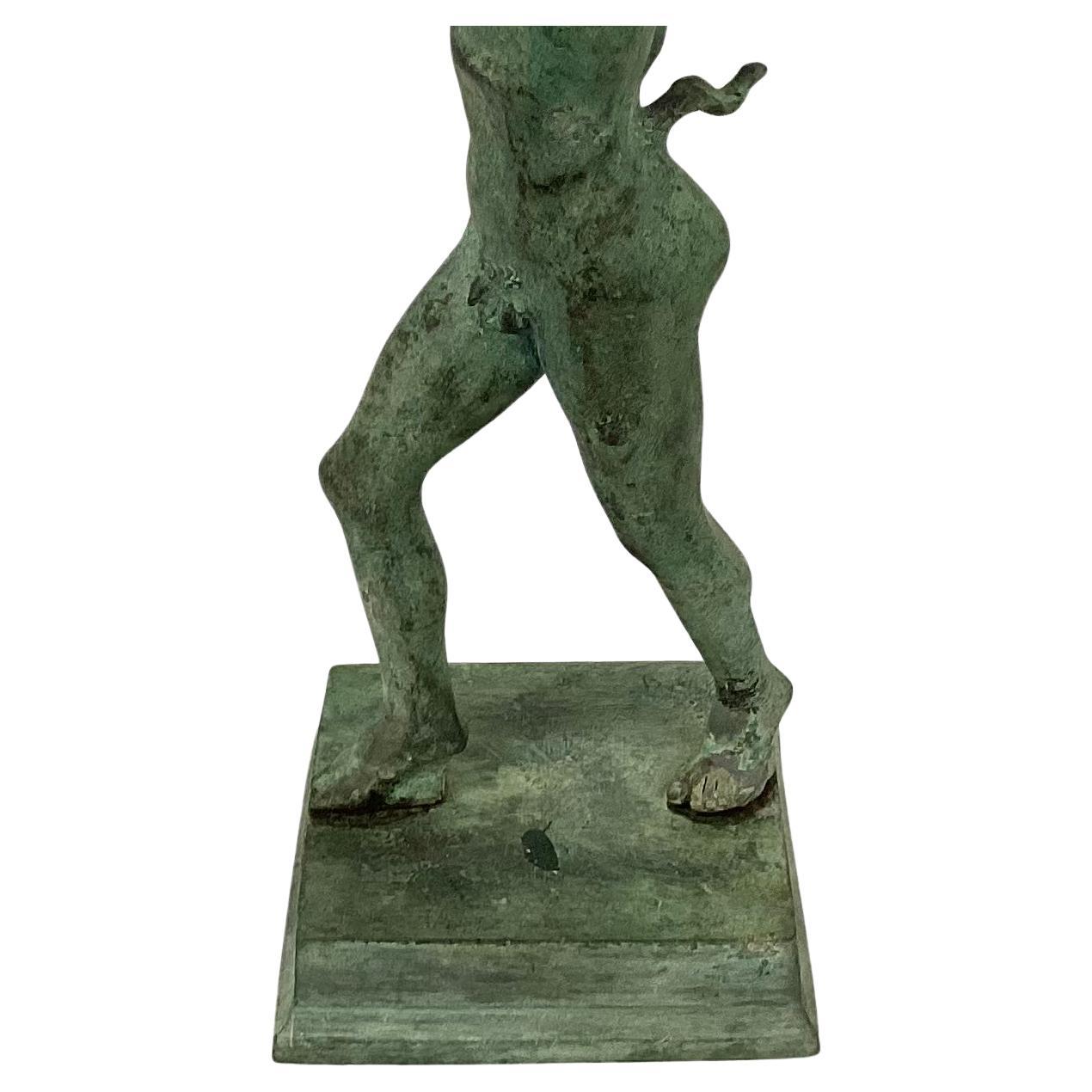Italian classical bronze sculpture of the Dancing Faun of Pompeii. Fauns were an example of spirits of untamed woodland, often connected to Pan and Greek satyrs by Romans, or followers of the Greek god of wine and agriculture, Dionysus. This joyful