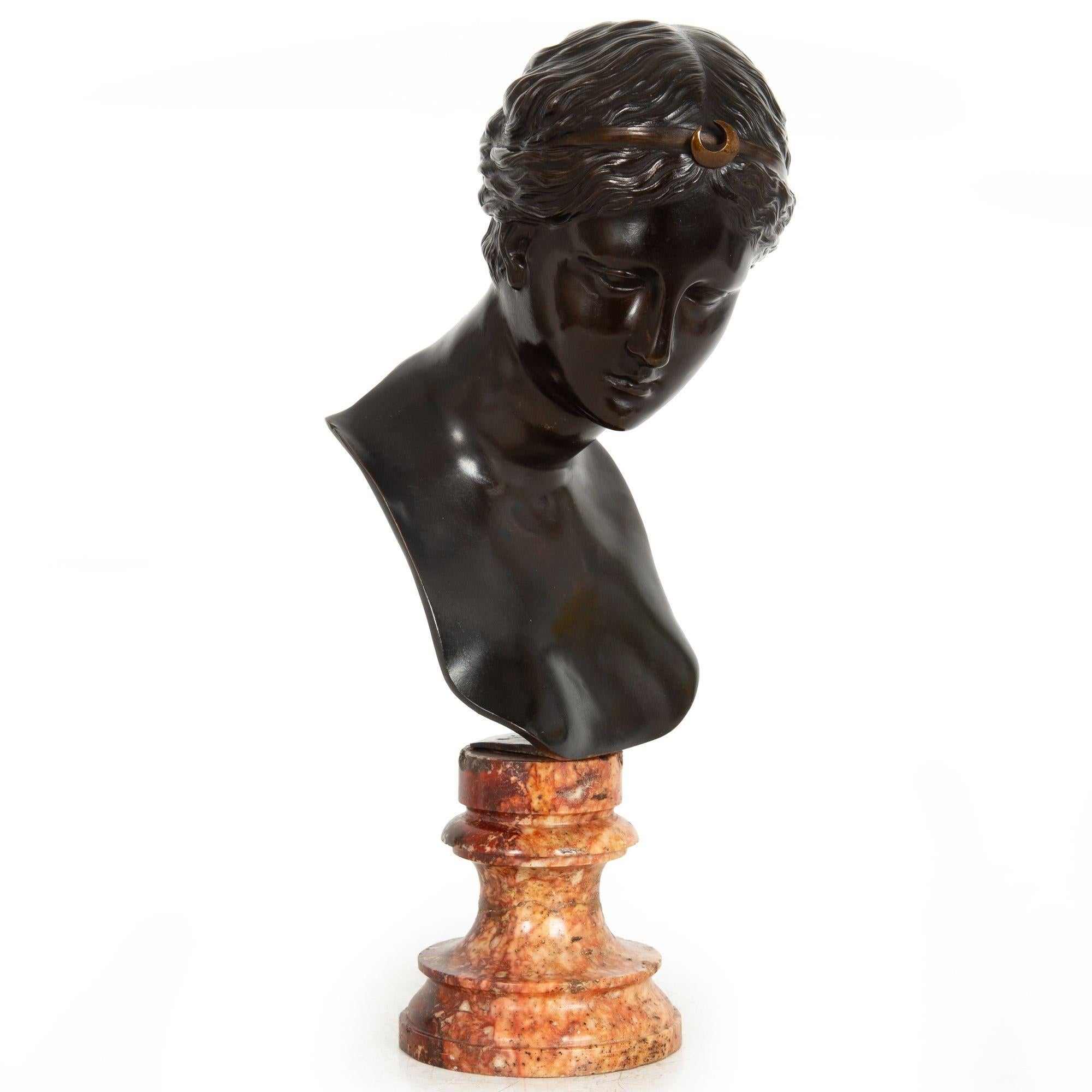GRAND TOUR
Italy, mid-19th century

Bust of the goddess Diana

Cast by Del Nero Foundry, Rome, crisp inscription to base of neck verso DEL NERO ROMA
Patinated bronze raised on a mottled pink marble plinth

14
