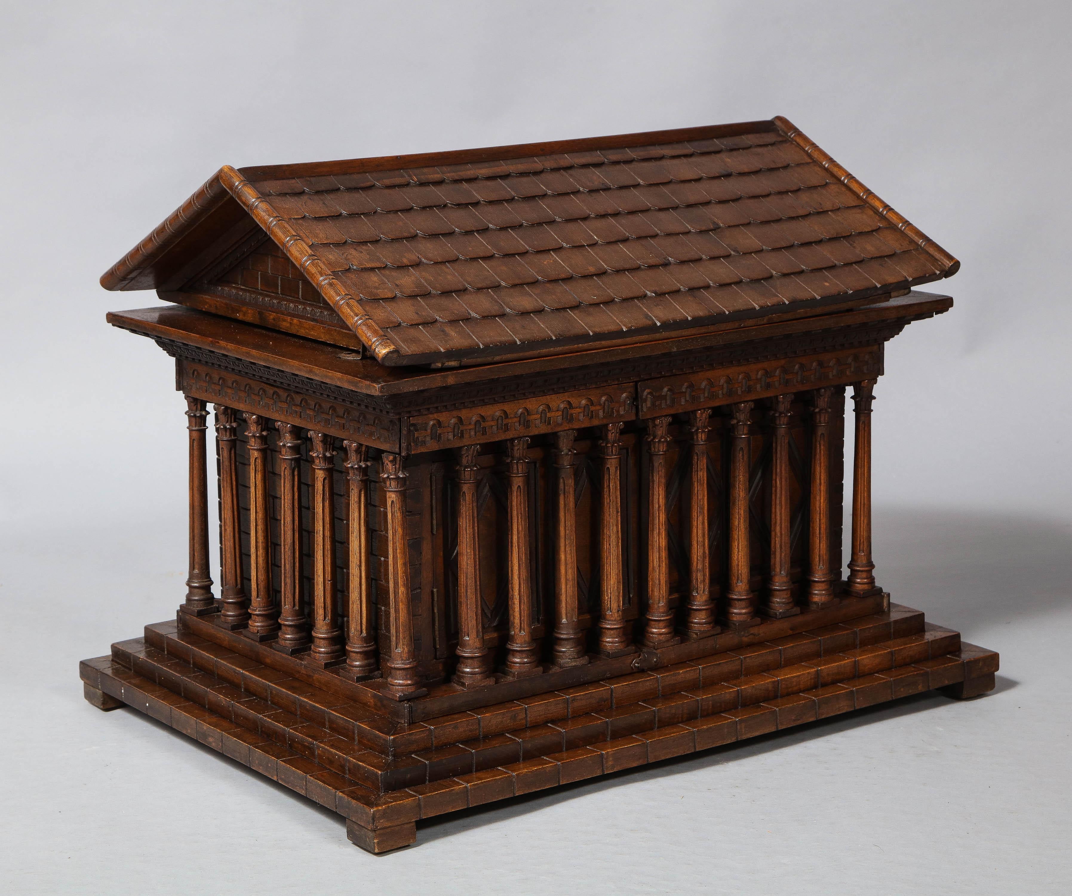 Very fine carved walnut architectural model of a Greco-Roman temple, with hinged lid and column fronted doors, circa 1840, each row of columns either hinged or removable, possibly made as an apprentice piece or perhaps just an intriguing