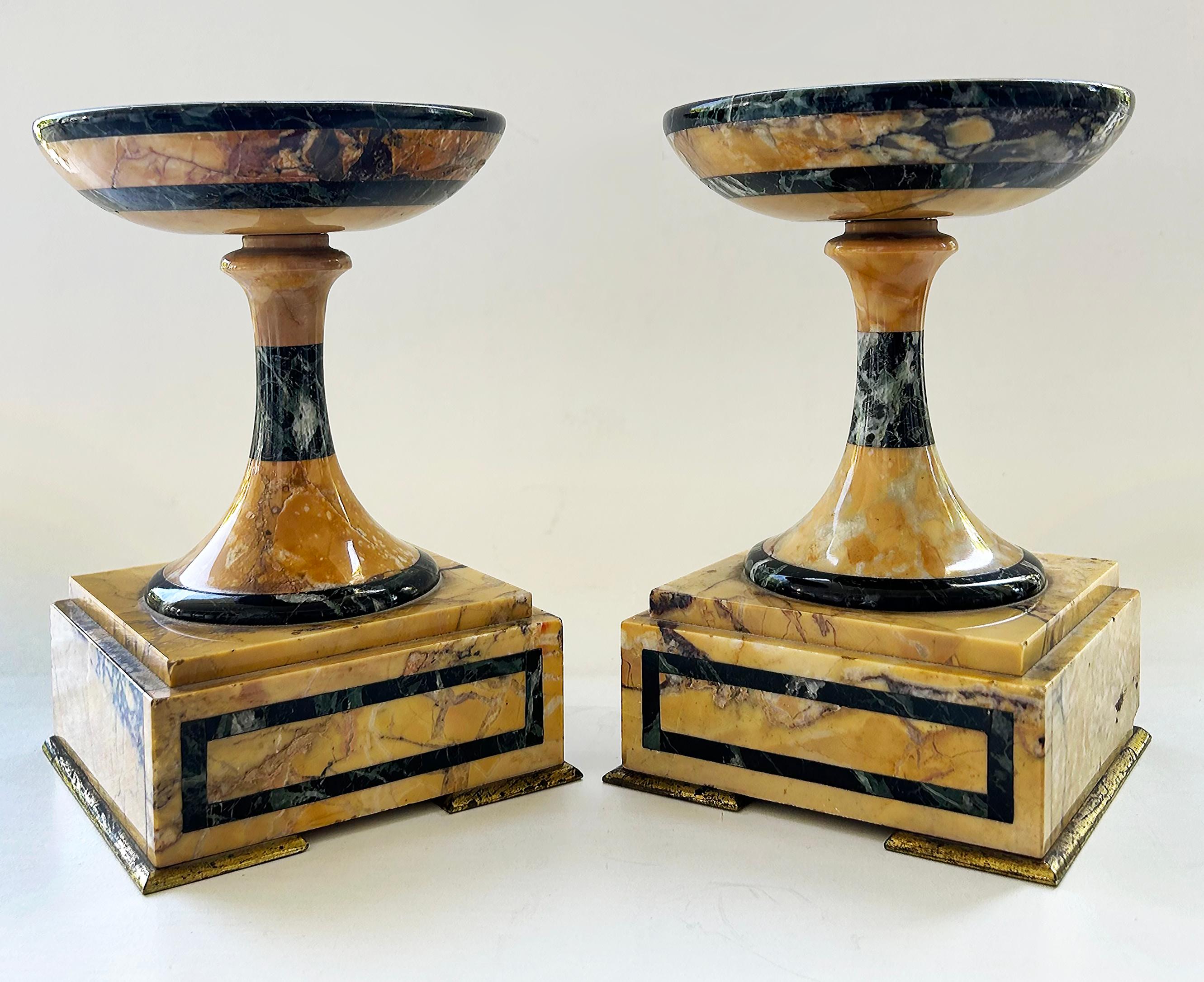 Italian Grand Tour Marble and Gilt Bronze Garniture Tazzas, a Pair

Offered for sale is a pair of Grand Tour tazzas made of variegated marble and bronze accents. The tazzas are created with richly veined Italian Sienna marble. the will make quite a