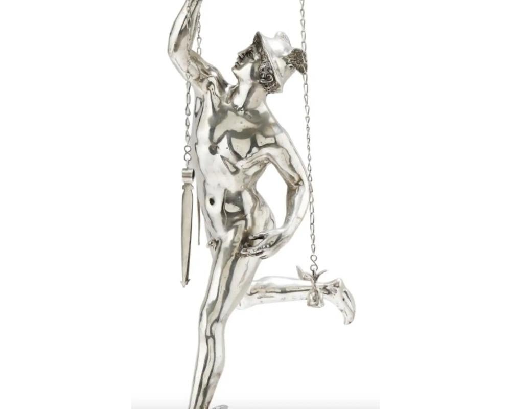 An Italian grand tour silver table library lamp depicting mercury, Rome, circa 1830, after the Antique.

With Italian silver hallmarks and makers marks throughout.

The stem representing the Giambologna Mercury, resting on a cylindrical base in