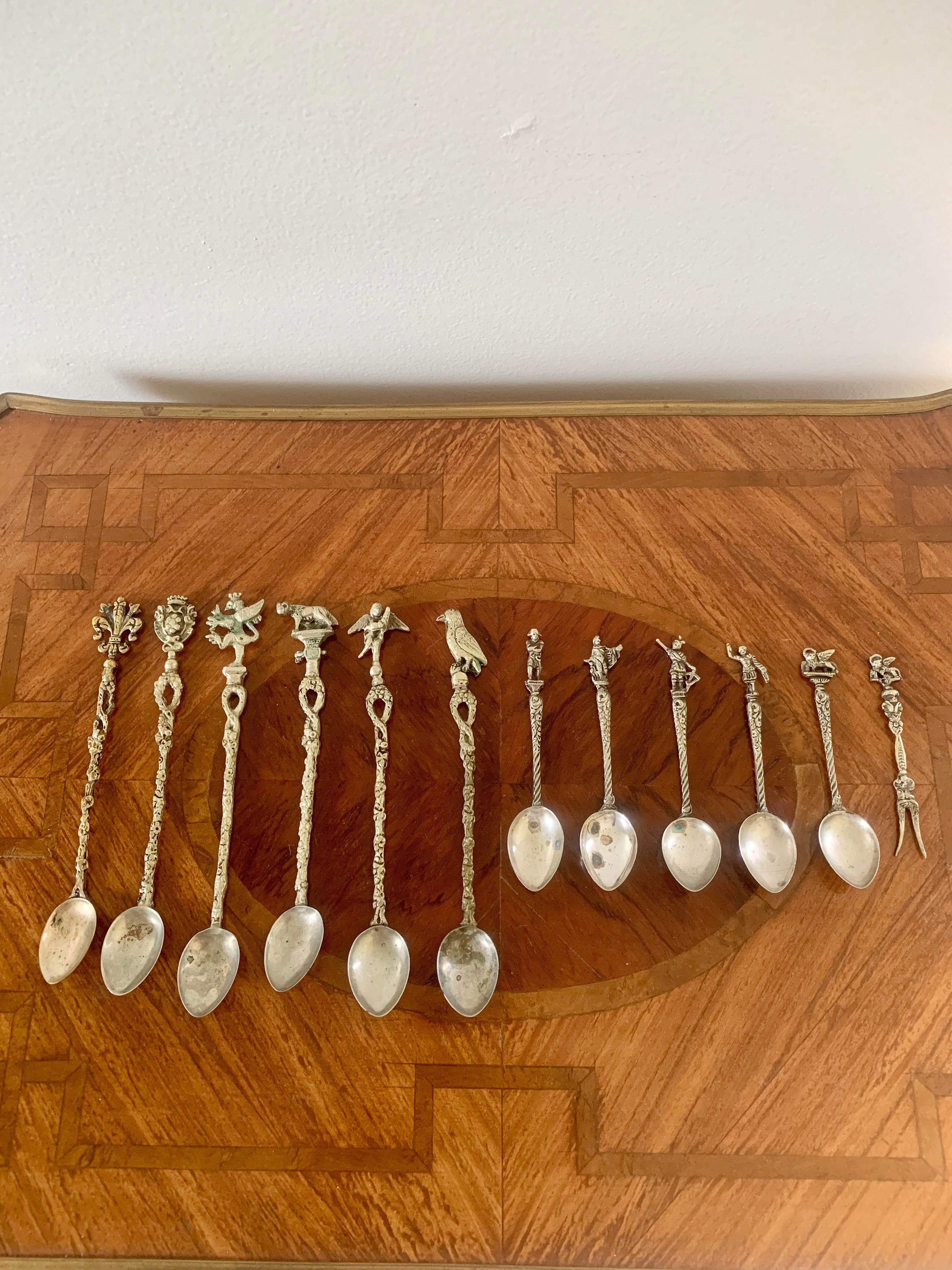 A set of 11 silver plate spoons and 1 cocktail fork with Italian landmarks and crests in the Grand Tour style. Made in Italy and marked Alpak.
Large: 7