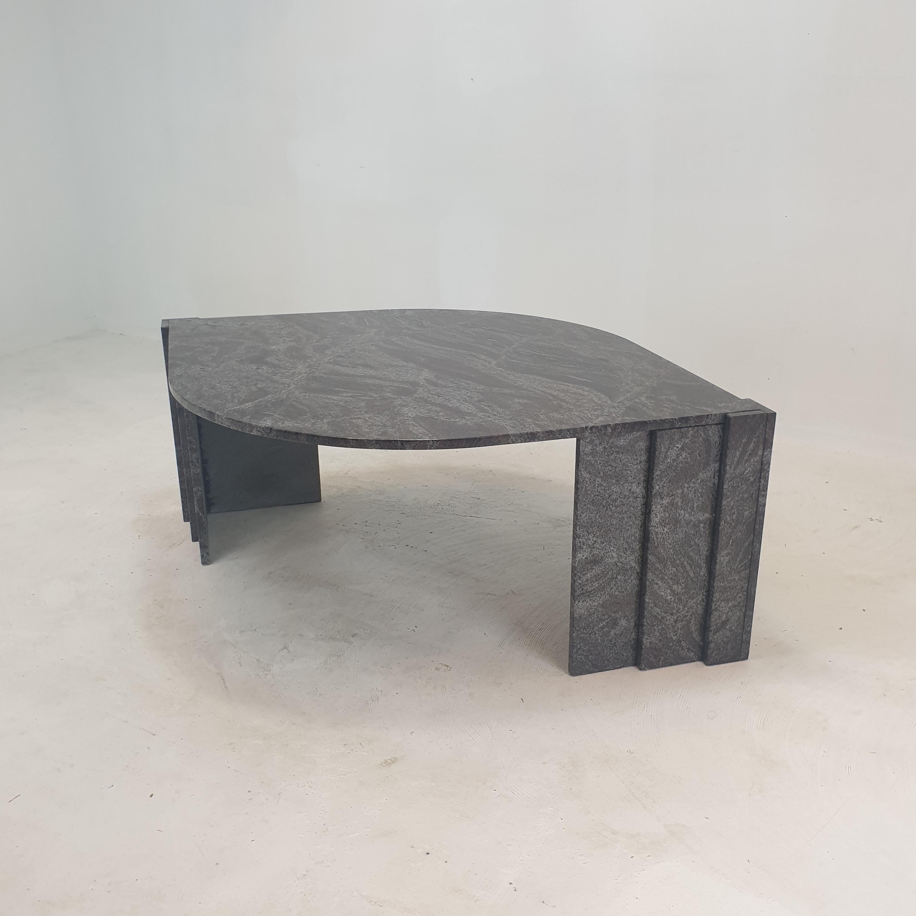 Very elegant Italian coffee table handcrafted out of granite, 1980's.

It has a very nice teardrop shaped top. 
It is made of beautiful granite.

The base is made of two separate pieces.

It has the normal traces of use, see the