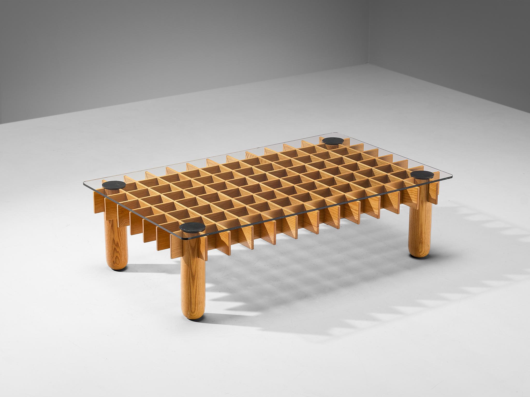 Coffee table, ash, rubber, glass, Italy, 1970s

This ash coffee table from Italy consists of a wooden grid, build up out of maple laths. Four solid round legs end up in four round ends. On top of the grid rests a glass top. The construction of the