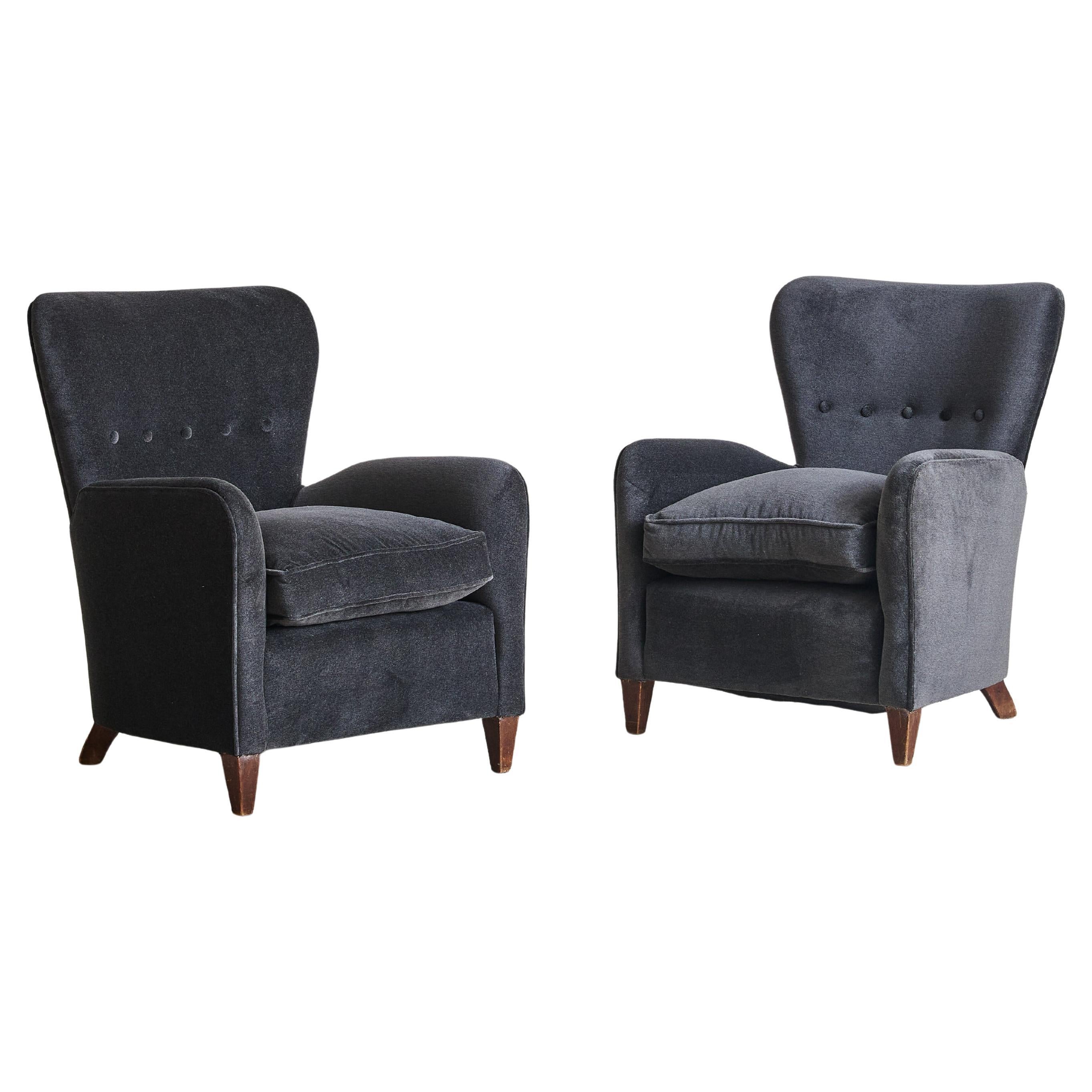 A 1950s Italian lounge chair, reupholstered in rich, charcoal-hued mohair with a luxurious sheen and softness. The clean, tailored lines are complemented by gently curved arms and a softly contoured backrest, accented with a row of button tufting.
