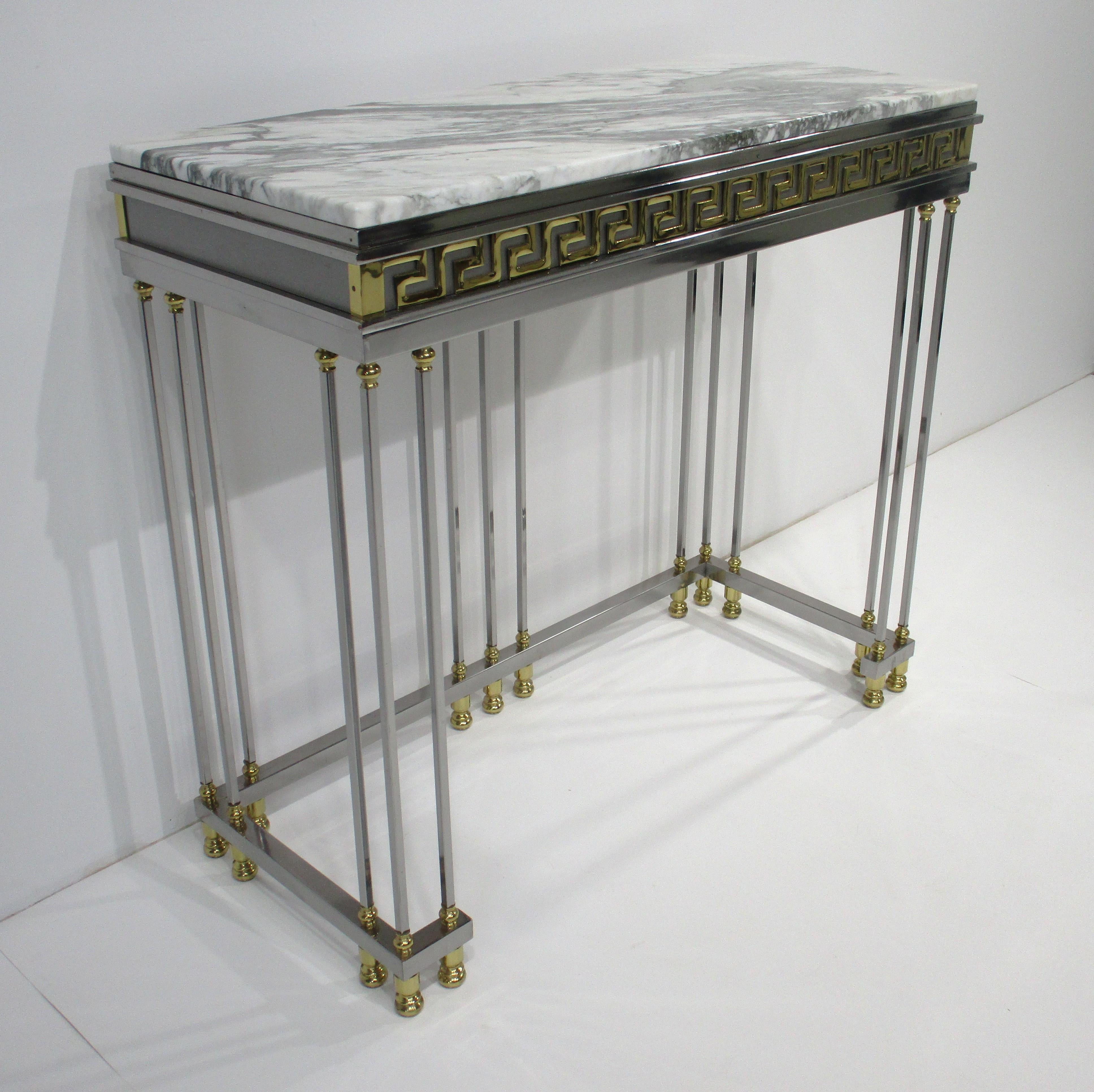 A exceptionally stunning veined carrara marble topped console table with chrome and brass frame . This is a superb very well crafted quality example of Mid Century 1970's luxurious Italian design that would work in an entrance way or below a mirror