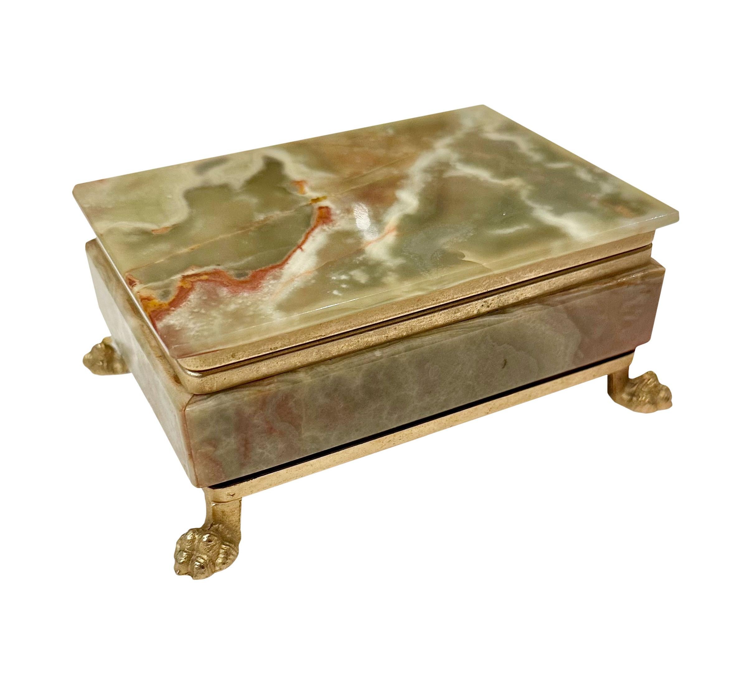 A green alabaster box with a hinged top.Box with brass trim and lion paw feet. Italy circa 1960s.