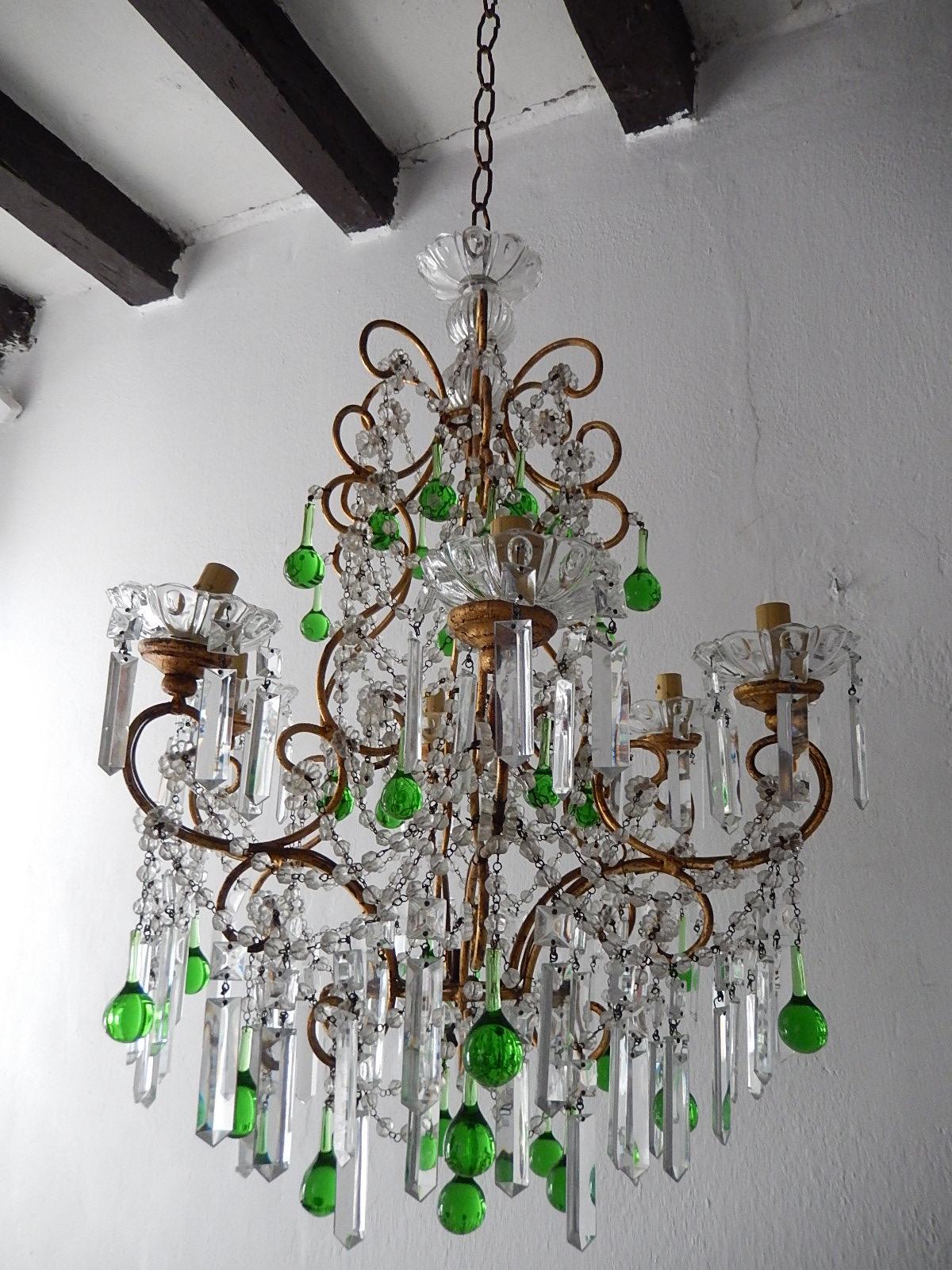 Housing 6-light, bobeches in crystal, dripping with vintage rare shape crystals sitting on giltwood posts. Swags of rock crystal beads, crystal prisms and rare green Murano drops. Adding another 10