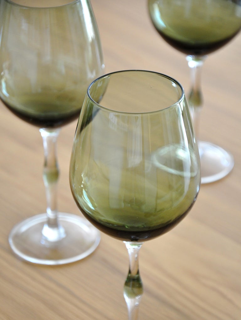 Beautifully hand-blown set of smokey-green wine glasses featuring thick, yet delicate faux bamboo style stems and wider mouth bowls. The cabernet shaped tops are designed to open the body, smooth out each note, and enhance the aroma and