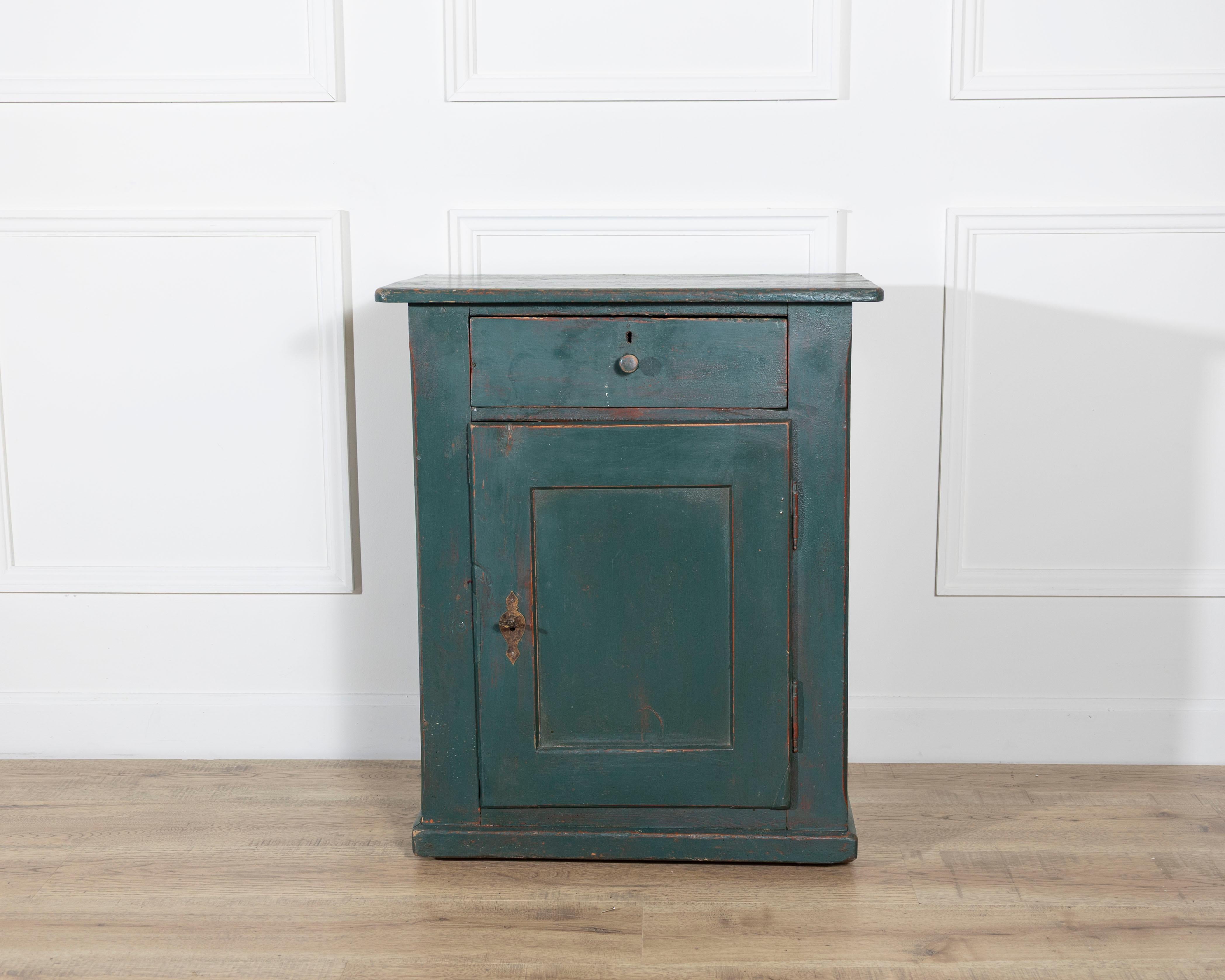 Charming and authentic, this green-lacquered bedside table dates to around 1830 and originates from the Alpine regions of Northern Italy. Crafted from solid fir wood — a material prized in Alpine furniture for its durability and natural resilience —