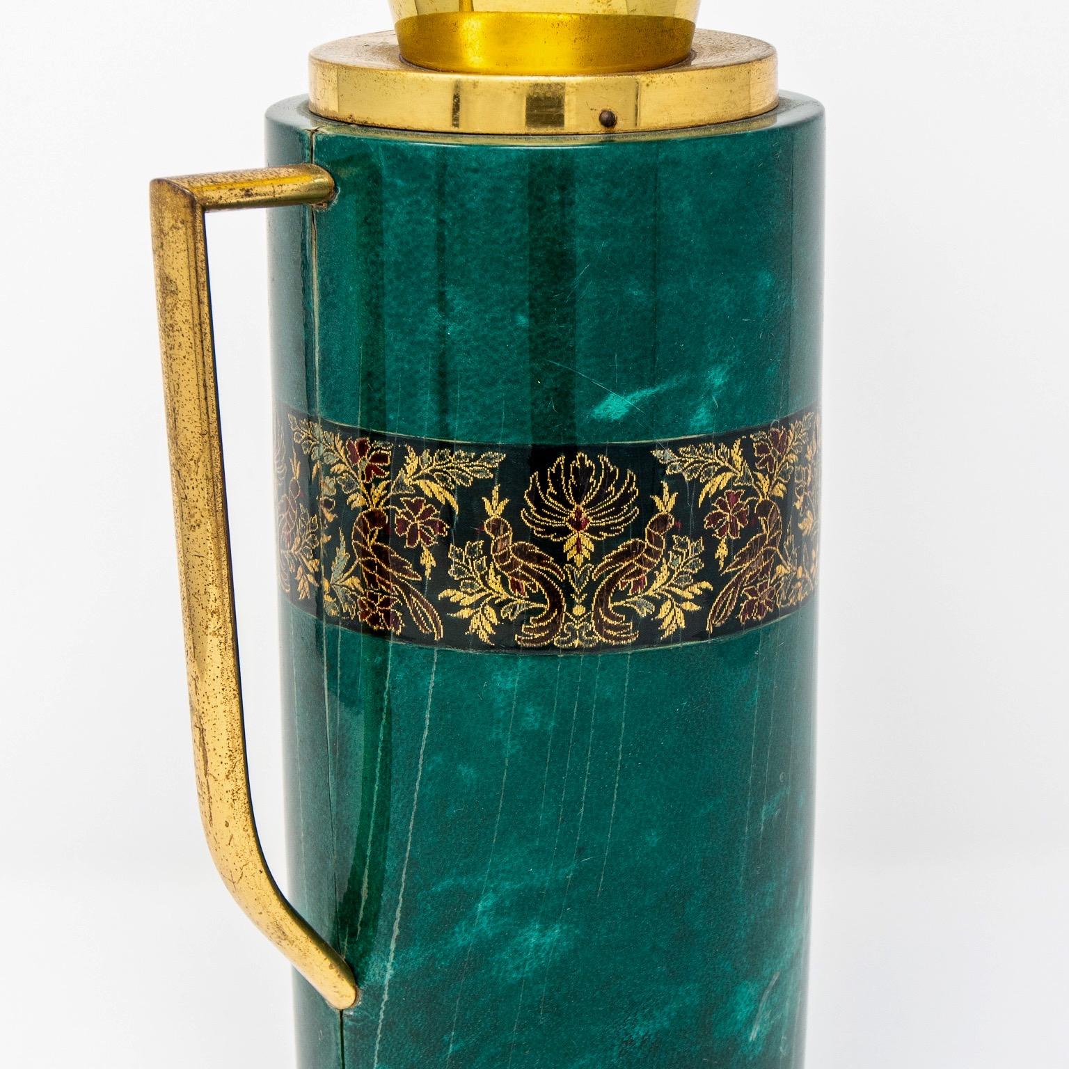 Barware decanter designed by Aldo Tura for Macabo features a leather-wrapped vessel with a malachite colored finish with brass handle and spout, circa 1950s. Cork stopper.


  