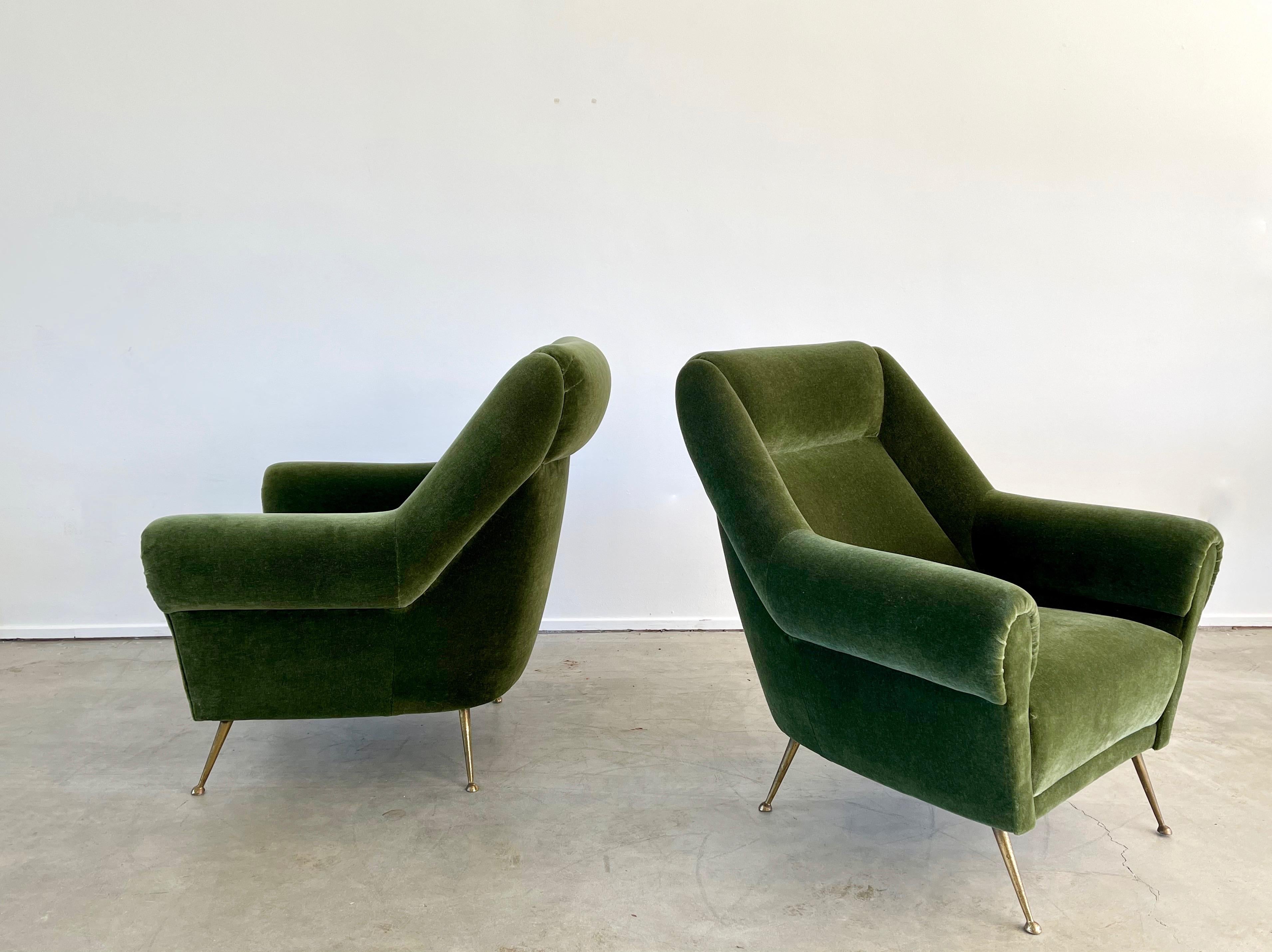 1950's Italian Lounge chairs reupholstered in olive green mohair with great curved arms and large in scale. 

Solid brass legs with great patina.
 