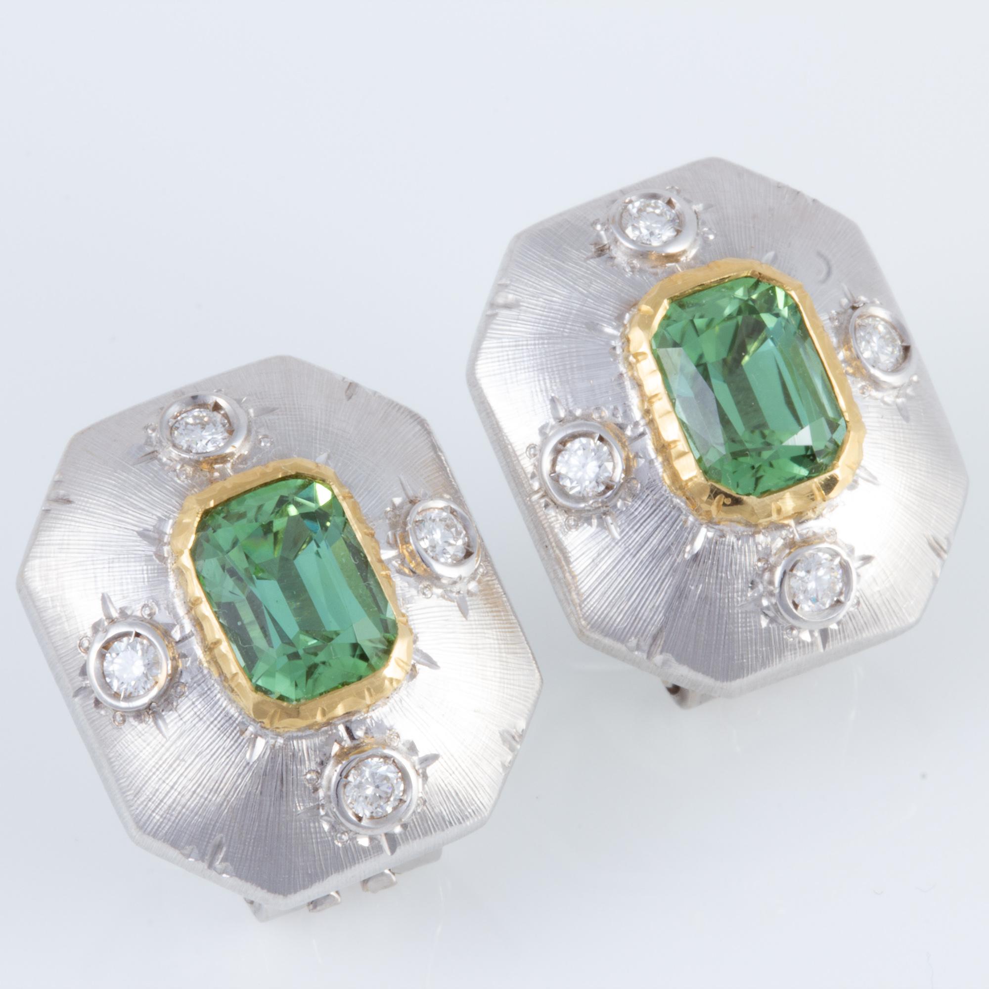 Handcrafted by Italian master jewelers in an old world Florentine style, these exquisite Tourmaline earrings are set in  beautifully hand engraved settings in two tone 18 kt gold.  This green  Tourmalines weigh 2.81 carats. The total diamond weight