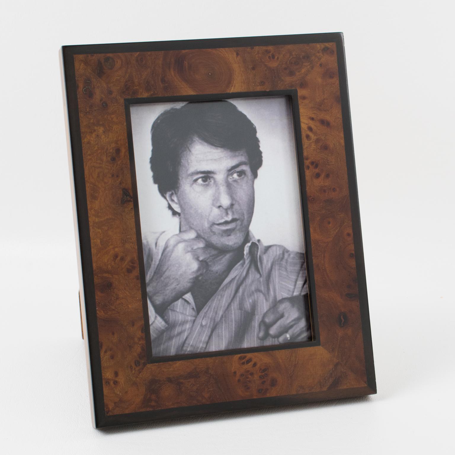 Superb picture photo frame by Italian designer Gucci. Timeless and elegant burl wood marquetry. Back and easel in wood with gilt metal hardware and Gucci company logo. 
Measurements:
Overall: 5.50 in. wide (14 cm) x 7.07 in. high (18 cm).
Opening