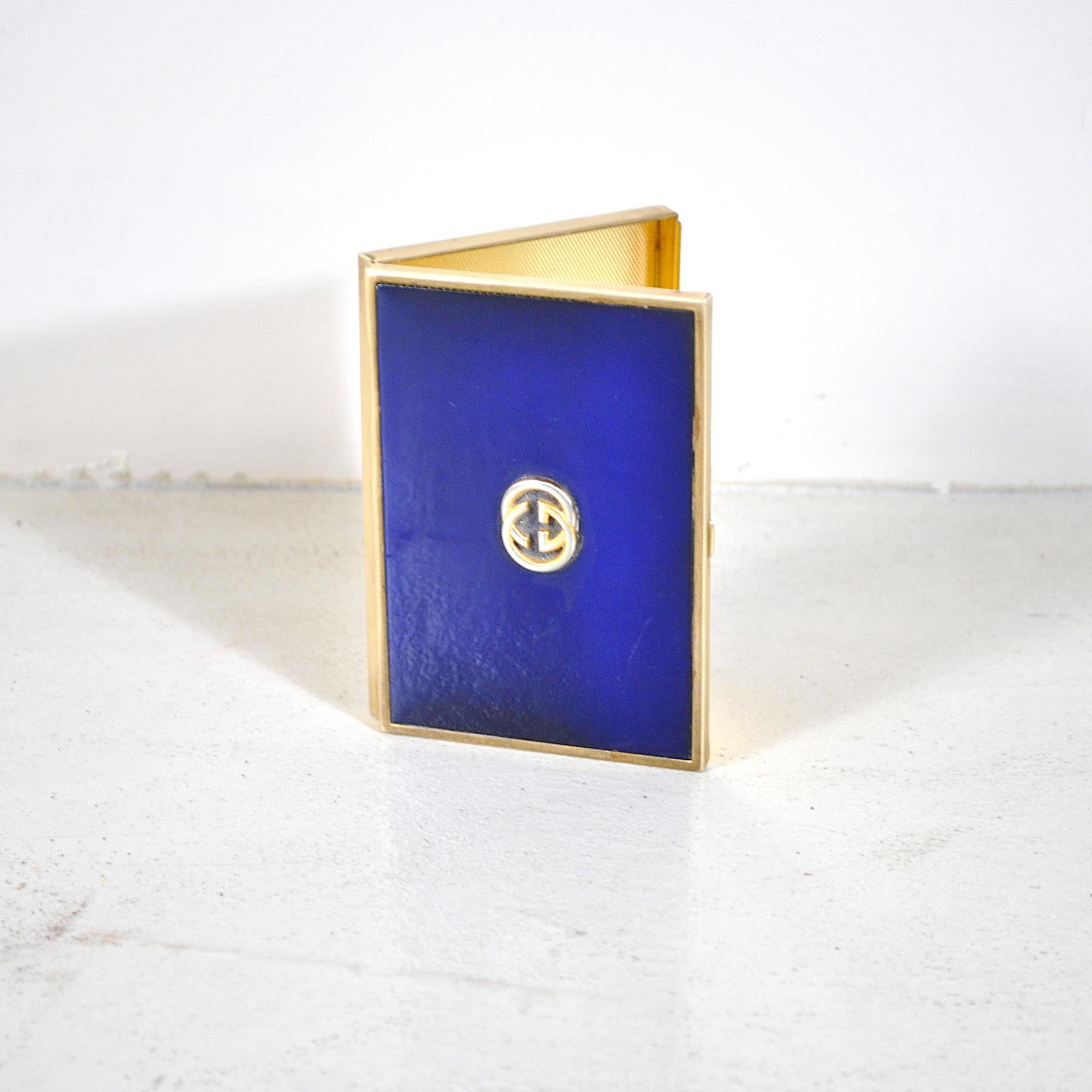 Brass cigarette case and gold and blue lacquered metal on the front, embossed logo on the front. Gucci production late 1960s.
