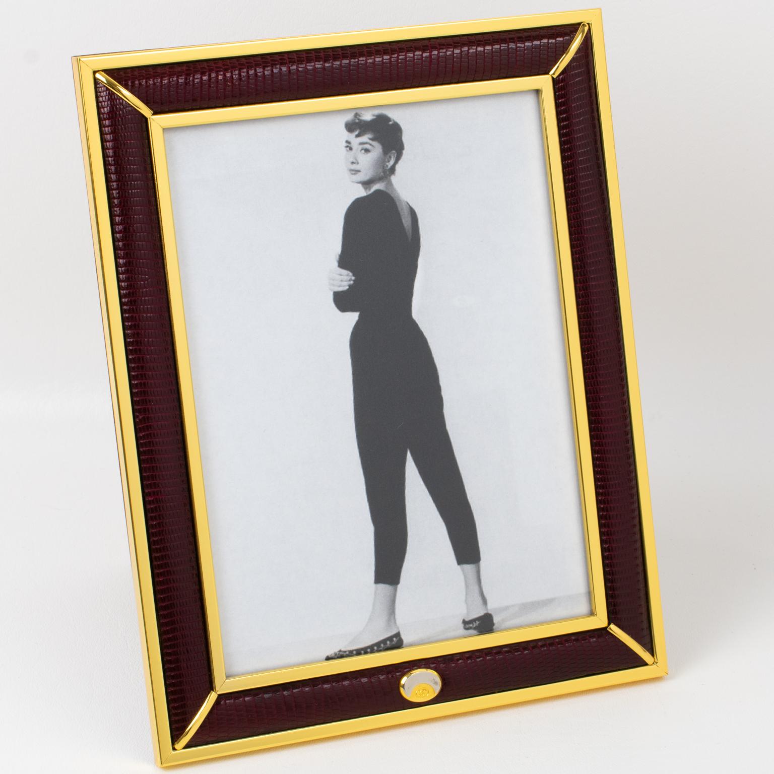 Superb picture photo frame by Italian designer Gucci. Timeless and elegant burgundy red lizard skin leather compliments with gilded brass decor. Chrome and brass 