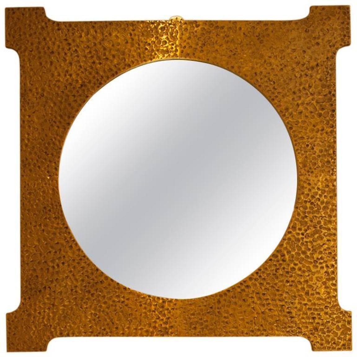 Large-scale Italian cast bronze mirror attributed to Luciano Frigerio. Mirror features hand-hammered square bronze frame and circular center mirror.
  