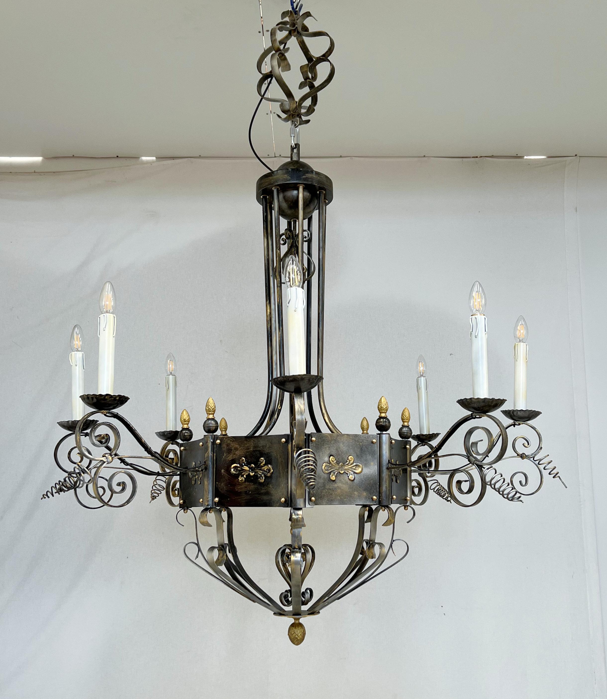 Italian chandelier with lacquered black iron hammered with ornate details painted with silver and gold / Designed by Fabio Bergomi for Fabio Ltd / Made in Italy
8 lights / E12 or E14 type / max 40W each
Measures: Diameter 55 inches / Height 59