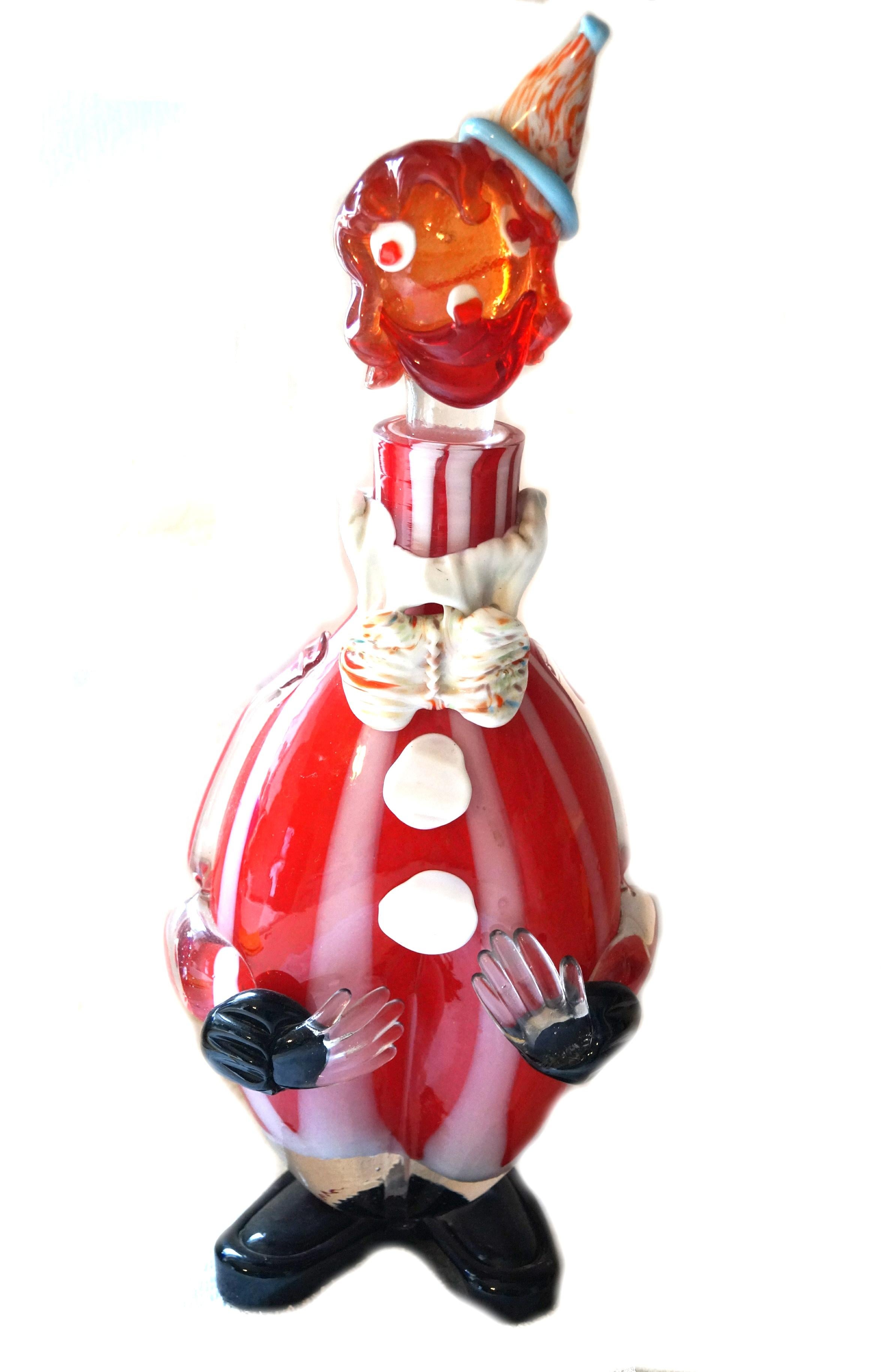This Italian hand blown murano glass clown decanter with stopper red orange black blue etc. We believe he may be a boy / man as it appears as though he has a bow tie.