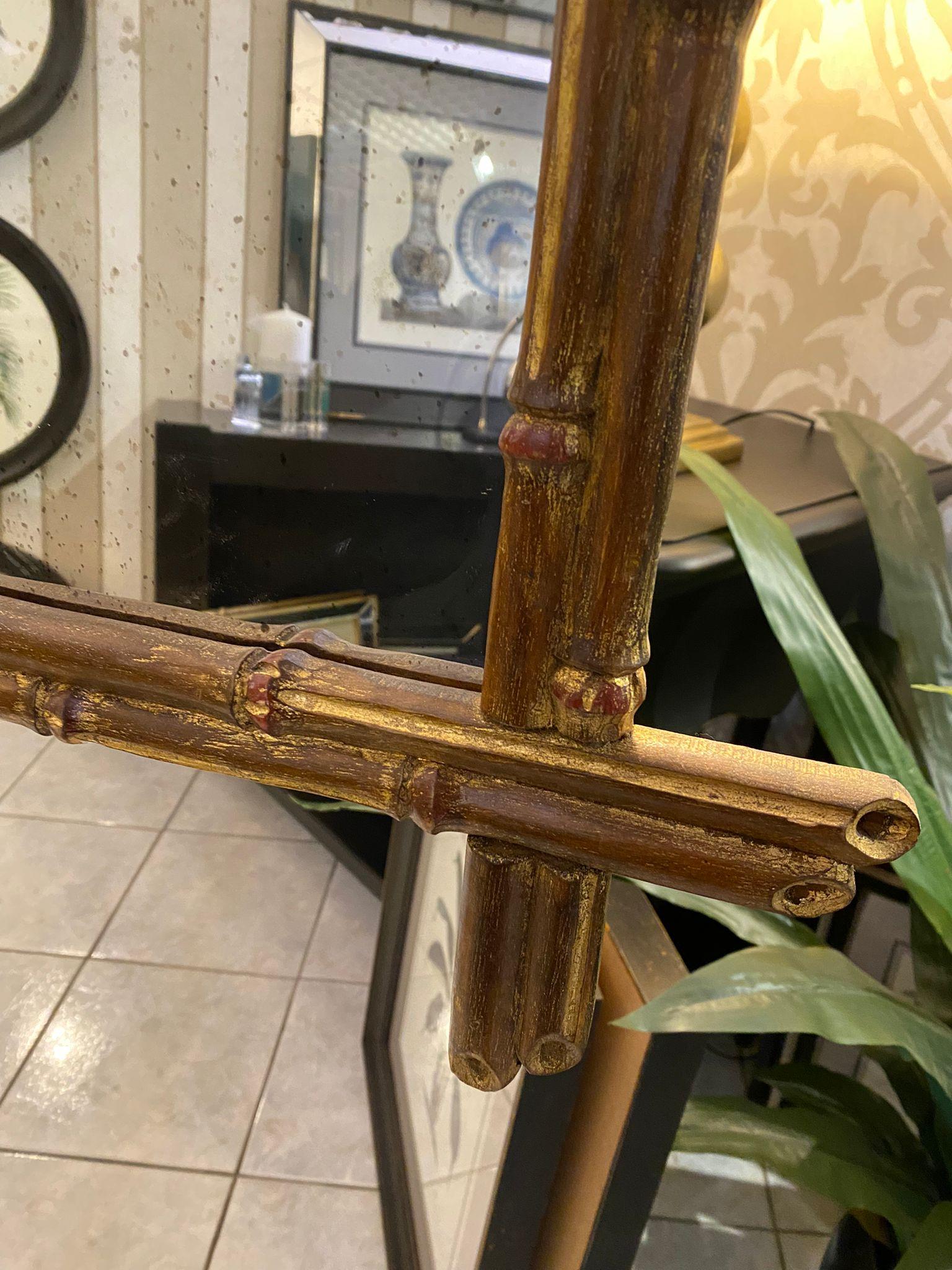 A hand-carved faux bamboo structure make this mirror exclusive and elegant. Each section of bamboo branch and binding is individually sculpted and then layered with metallic gold leaf and burnished with agate to increase the luster. Completed with