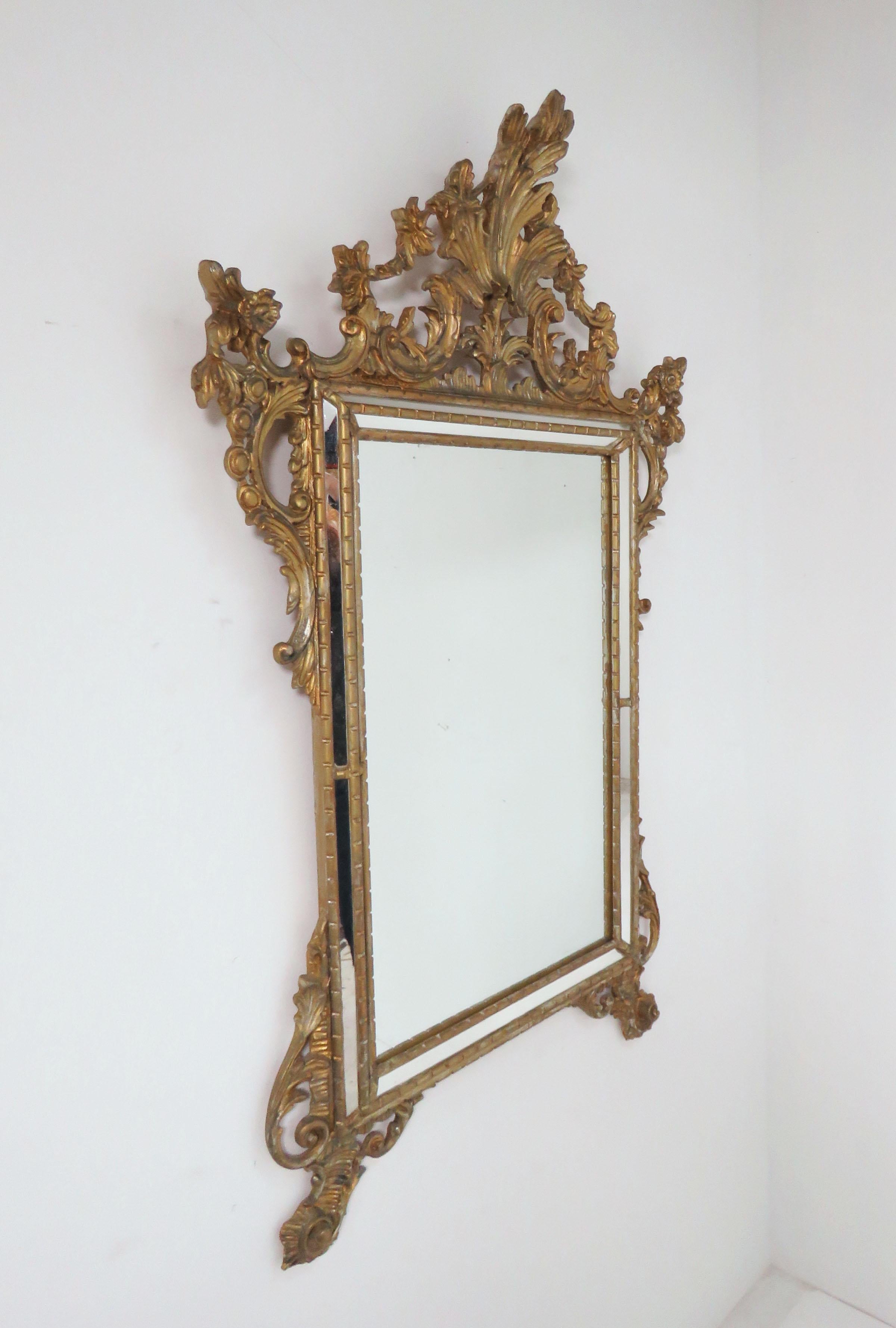 A vintage hand carved giltwood Venetian style wall mirror by Casa Bique, made in Italy, circa mid-late 20th century.
