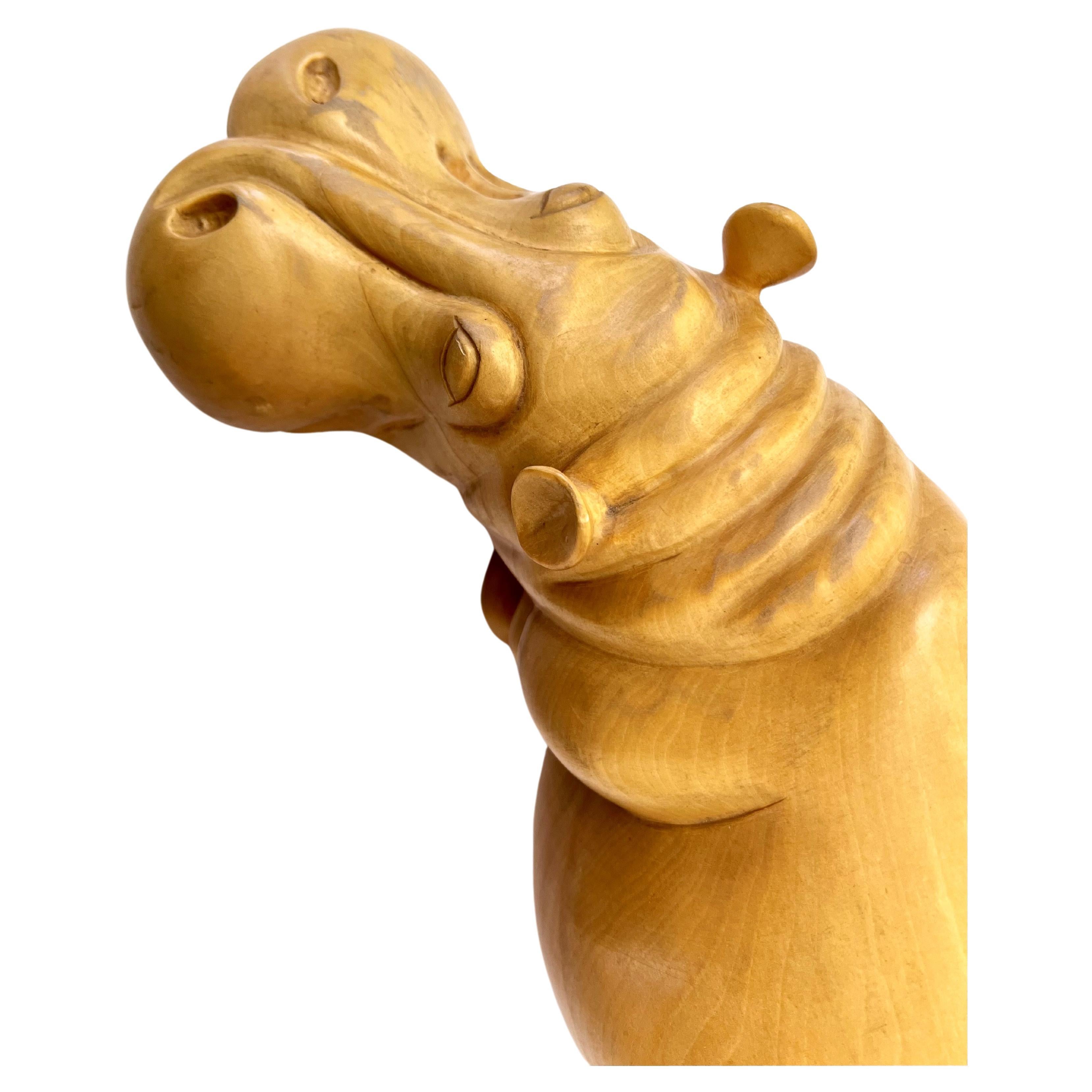 Fabulous XL Hand Carved Wooden Hippo Sculpture from Florence, Italy.   A whimsical and unique sculpture he's sure to make a happy statement. 
From François-Xavier and Claude Lalanne to Bitossi, hippos are a midcentury animal that are both amazing