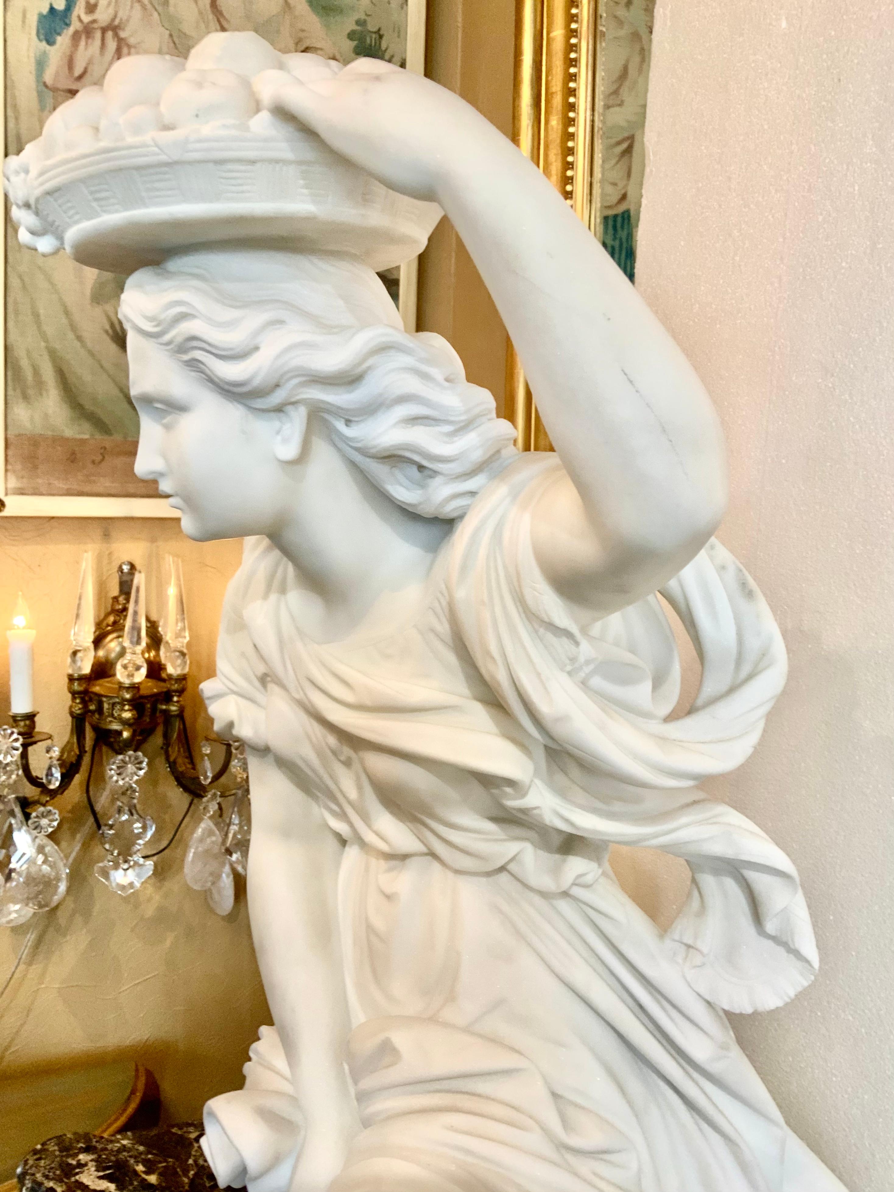 This Italian hand carved marble is of a standing beauty holding a basket
Of fruit on top of her head. It is carved in Carrara white marble and the
Condition is beautiful. There are very slight flea bite chips on the back
Corners of the plinth.