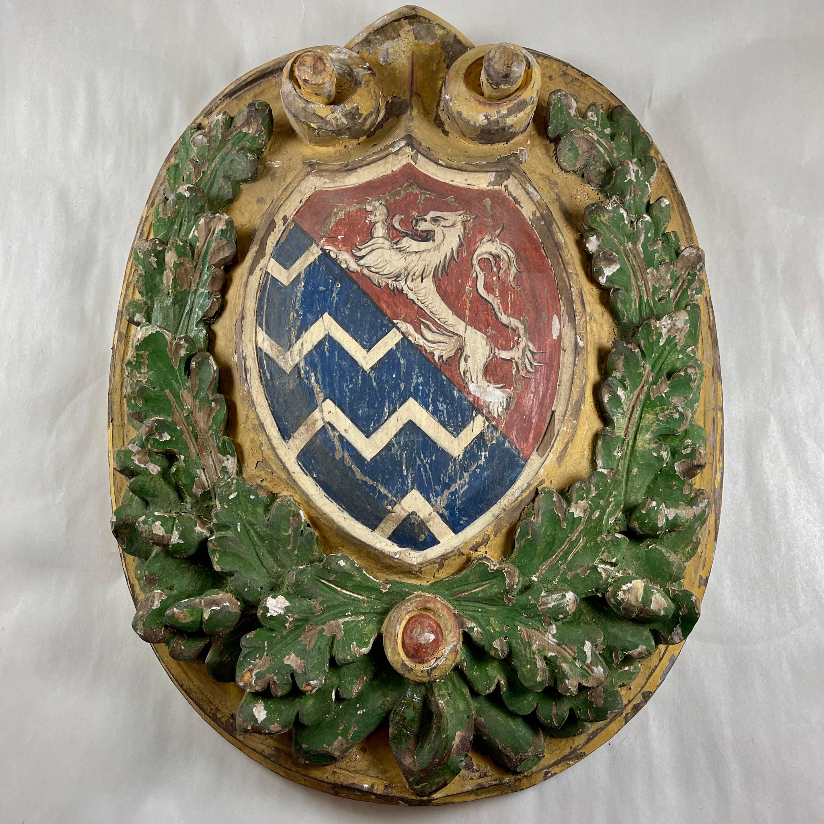 From Italy, in the Renaissance Revival style, a carved and painted wooden plaque with crest, circa 1870s.

A unique piece, carved and painted by hand, showing a Heraldic Crest against a bed of raised green oak leaves with acorns, on a scrolled