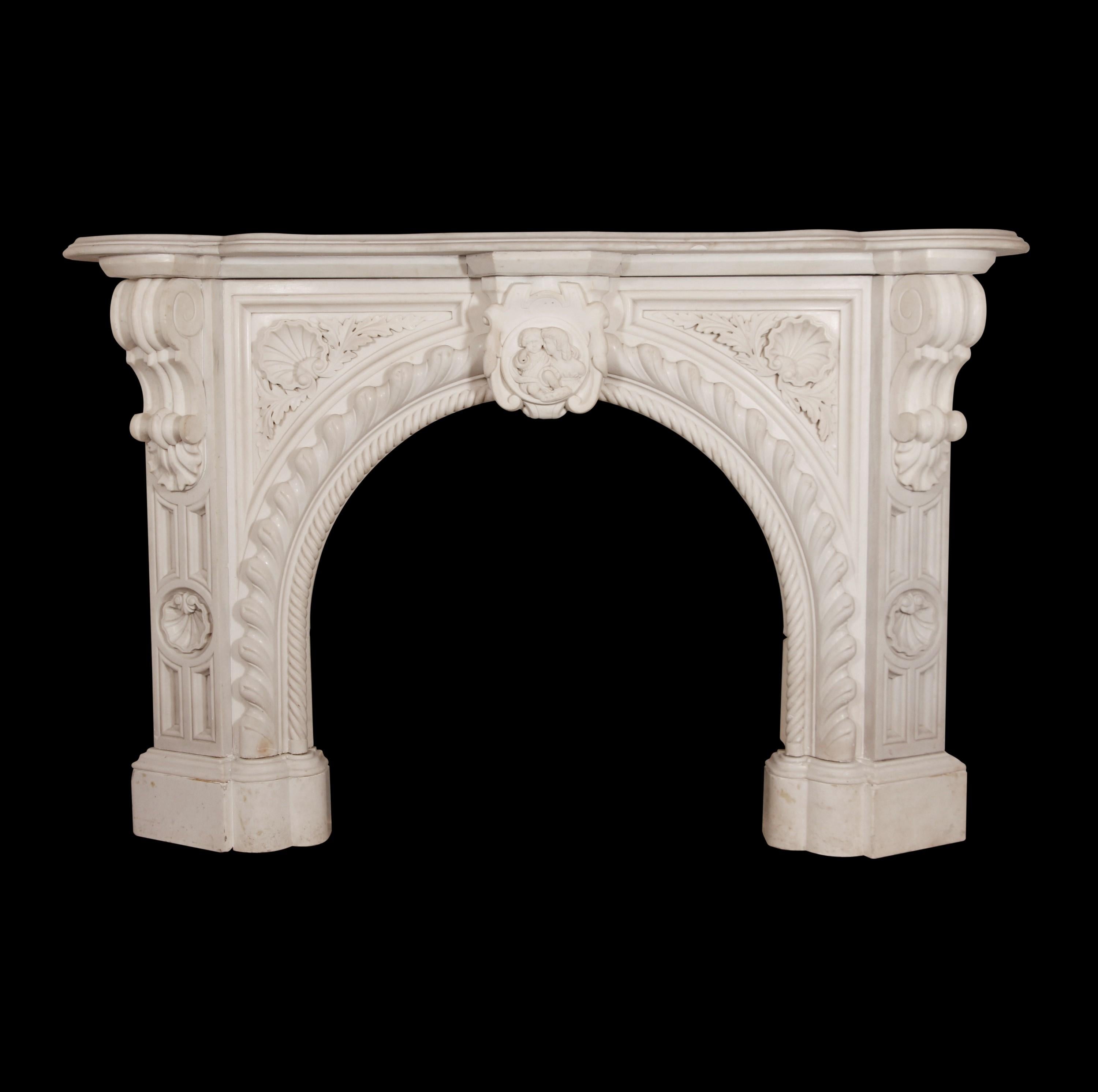 Mid-1860s highly carved Italian ornate mantel hand carved in a rope edge design. Features shells, floral details and a figural keystone. Sides are flanked by opposing large corbels.