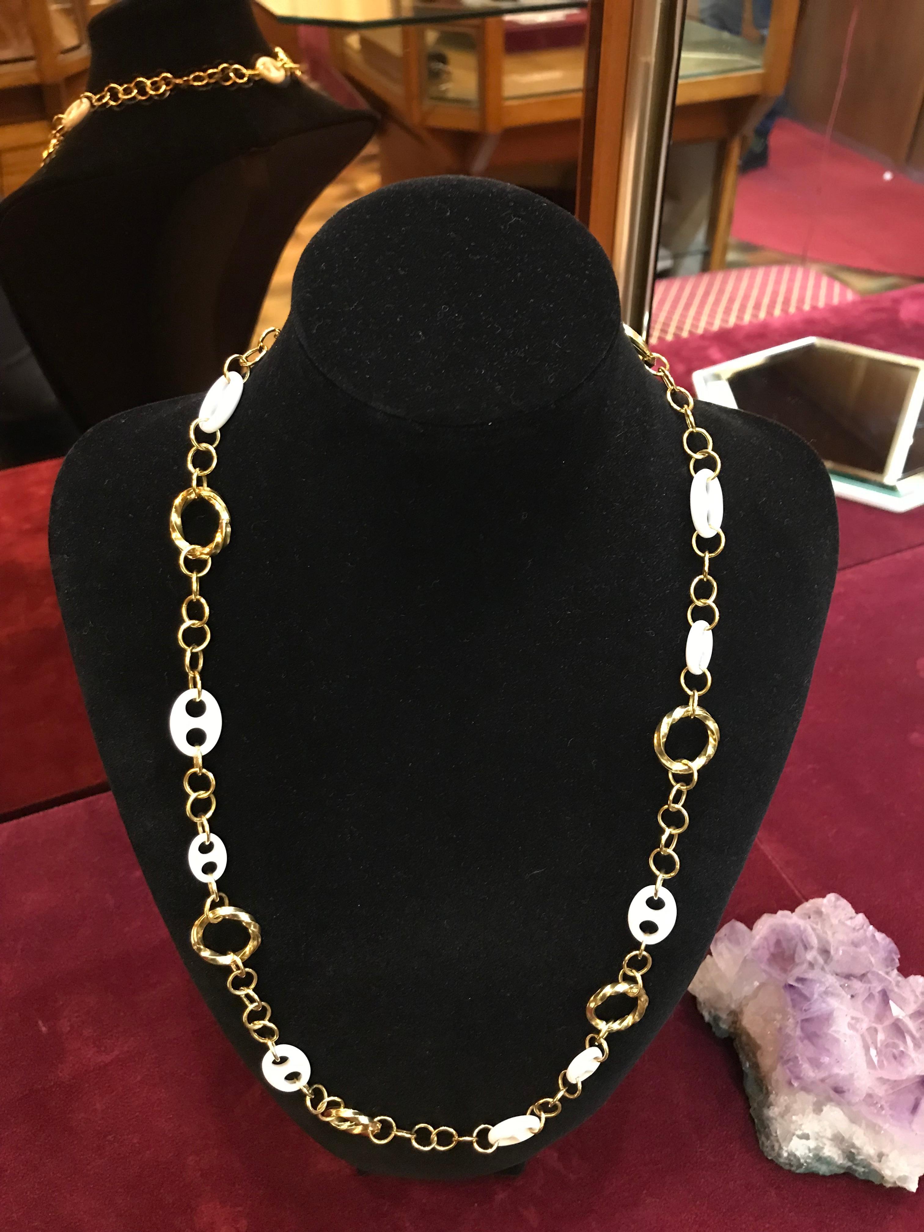 This detailed chain has been hand made in our Italian workshop. Smaller links join more detailed larger twisted circles and White Ceramic details. I’ve always envisaged it being worn with a linen shirt or dress on a summer’s day (preferably sitting