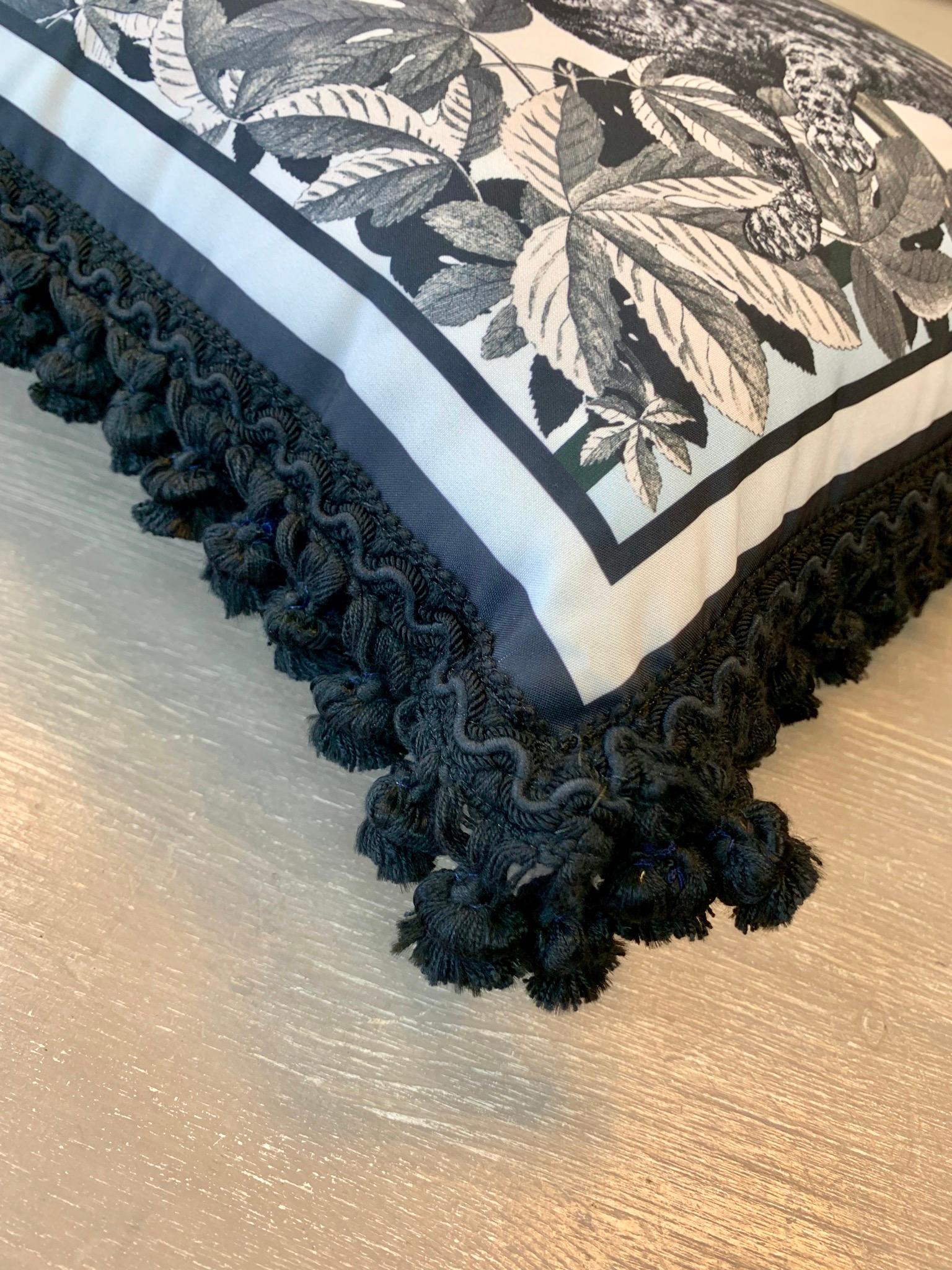 A velvet and polyester pillow with black trimmings From the 