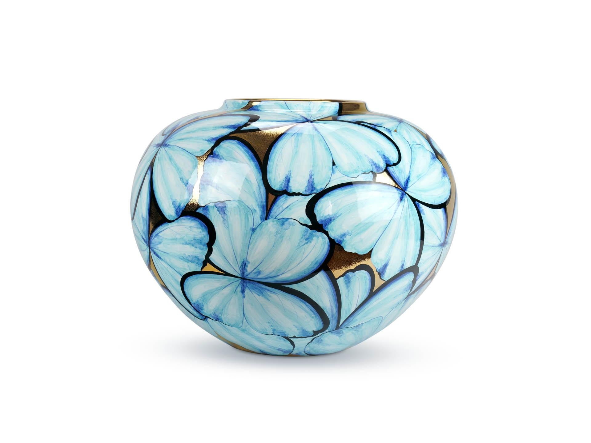 Our 'Petalouda Gold' majolica vase showcases the timeless allure of the blue butterfly capturing the essence of its elegance. Revered across cultures as a symbol of wishes fulfilled, joy, and transformation, the delicate beauty of these creatures