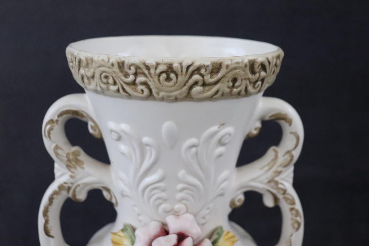 Italian hand painted porcelain biscuit vase, circa 1990s. Characterized by a classic line with floral decorations. Italian manufacturing brand imprinted in the base Capodimonte, historical production of italian artistic porcelain. 