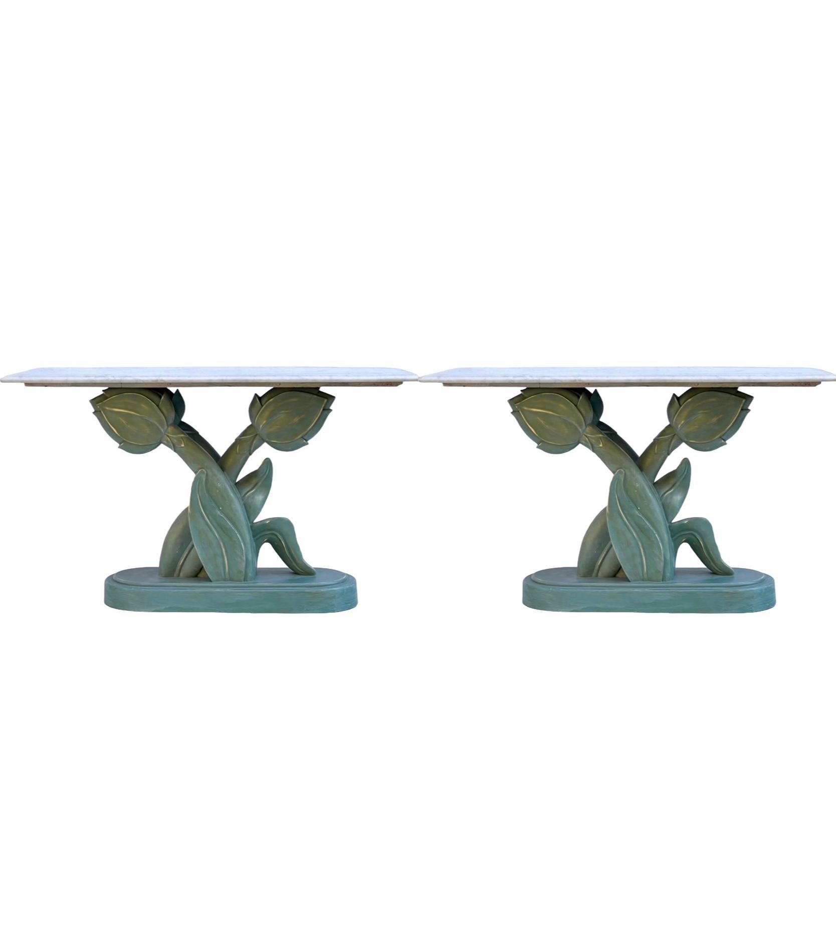 This is a pair of 1970s hand painted tulip form console tables with white marble tops attributed to Casa Bique. The marble tops are new. The tulip bases are a mix of wood a resin. The hand painted finish is a multi-faceted mix of ivory base tones