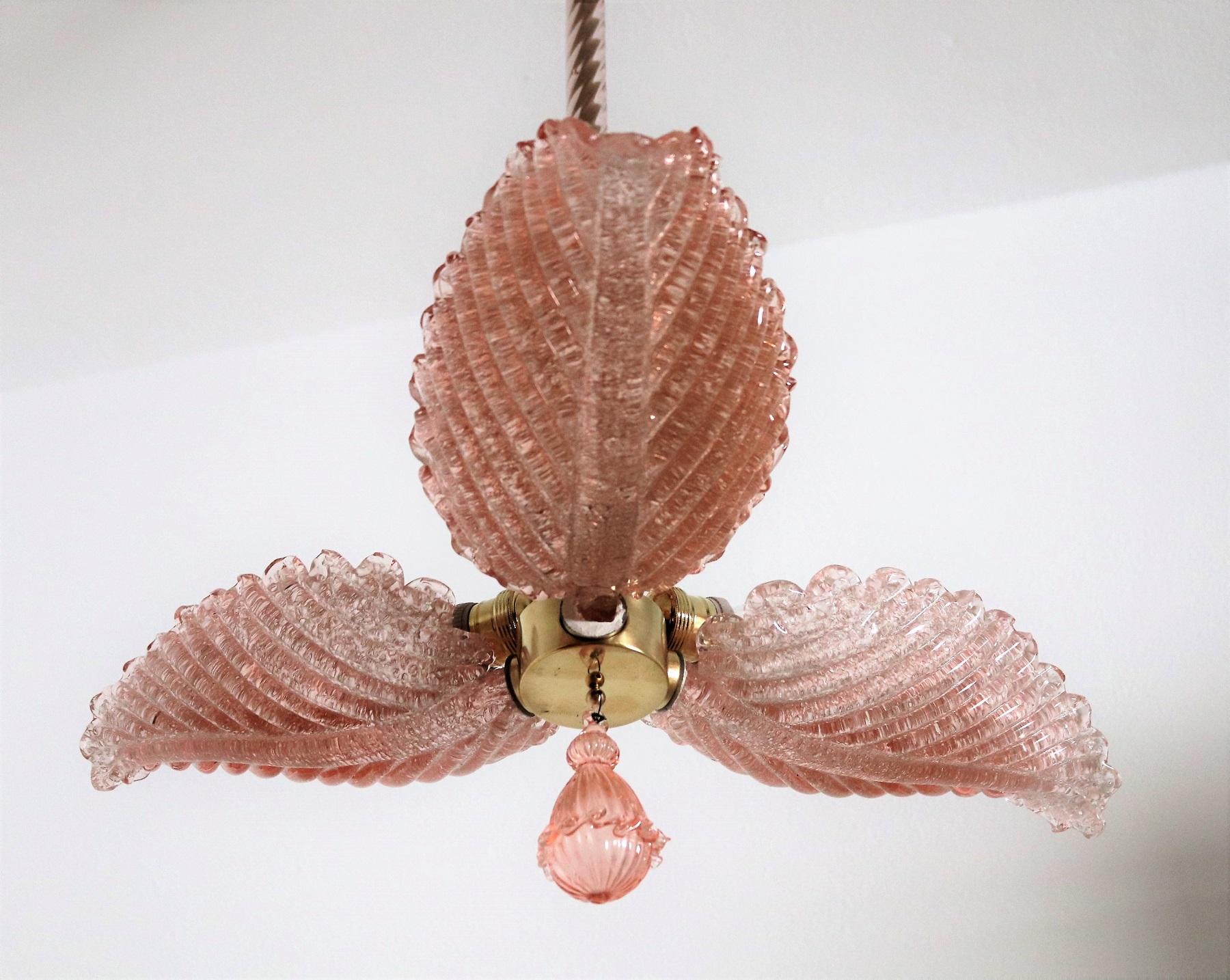 Magnificent and rare Italian chandelier handcrafted of pink or rose colored Murano glasses in the form of a flower. Below the chandelier a glass hanging detail typically for Venetian made Murano glass.
The glass petals are handmade and differ