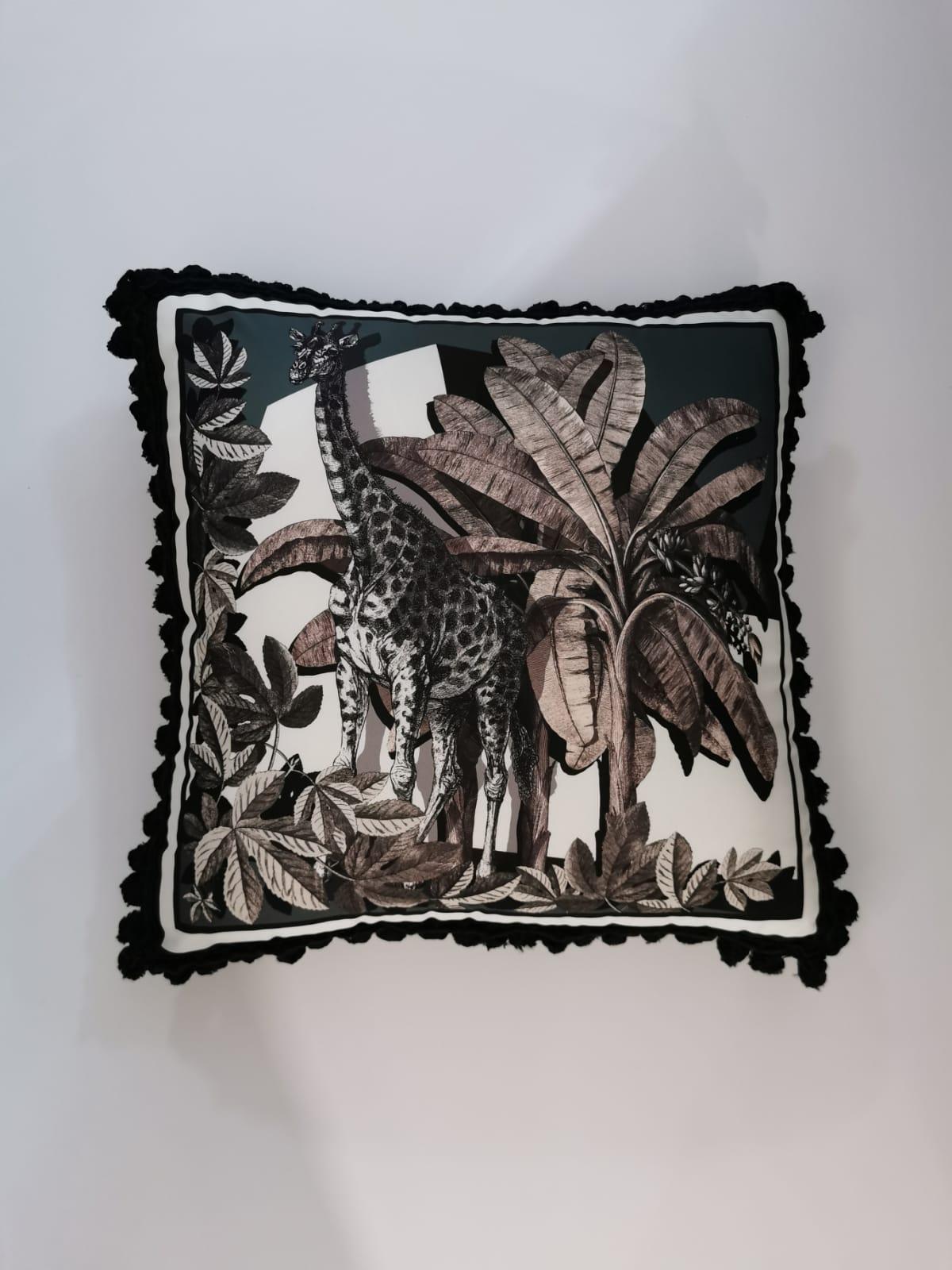 A velvet and polyester pillow with trimmings showing an exotic natural setting. It belongs to the 