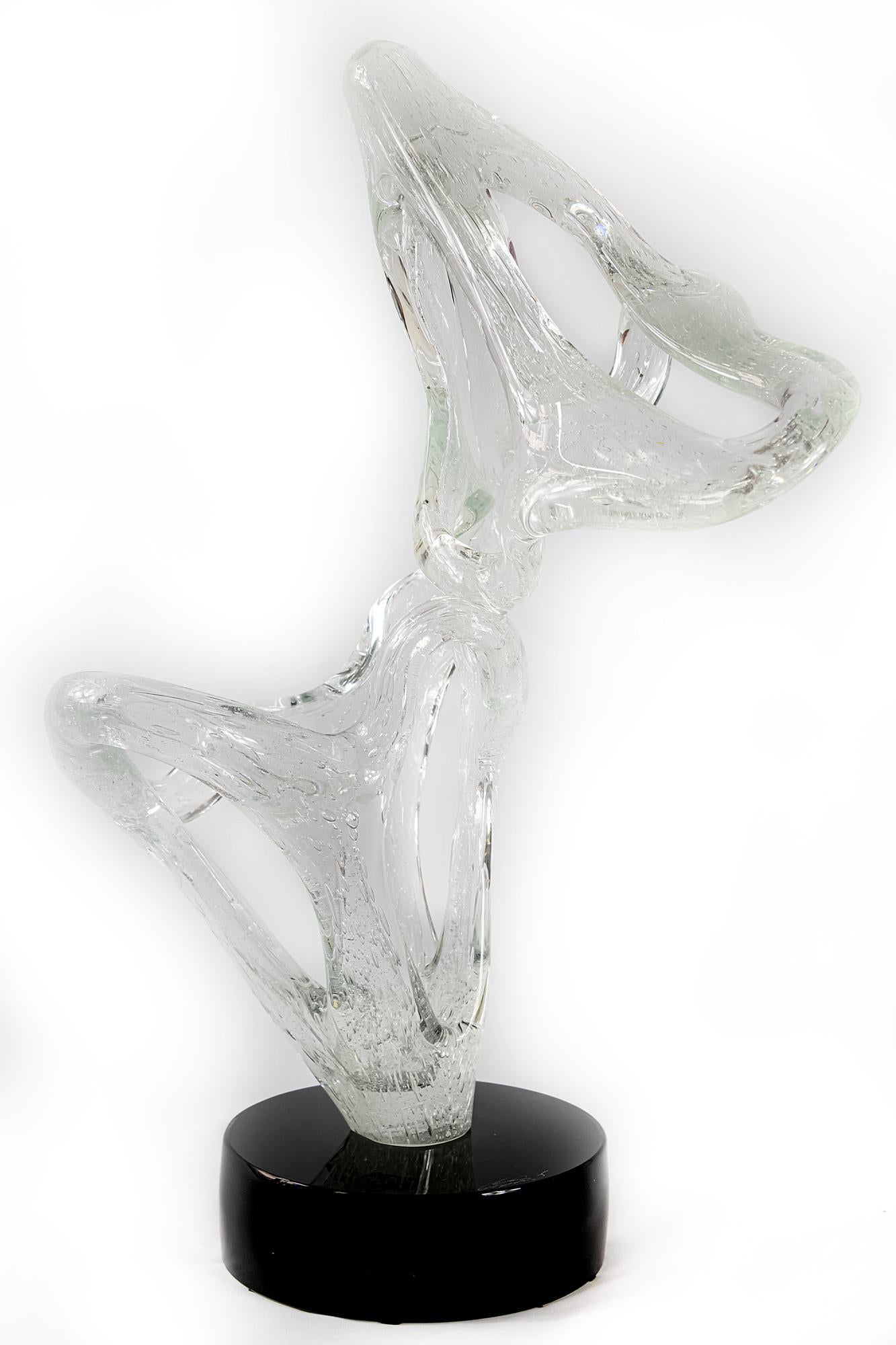 Italian handmade Murano glass abstract form sculpture. Signed Sergio Constantini.
The base is round black glass and the sculpture is transparent with bubbles inside blown glass.