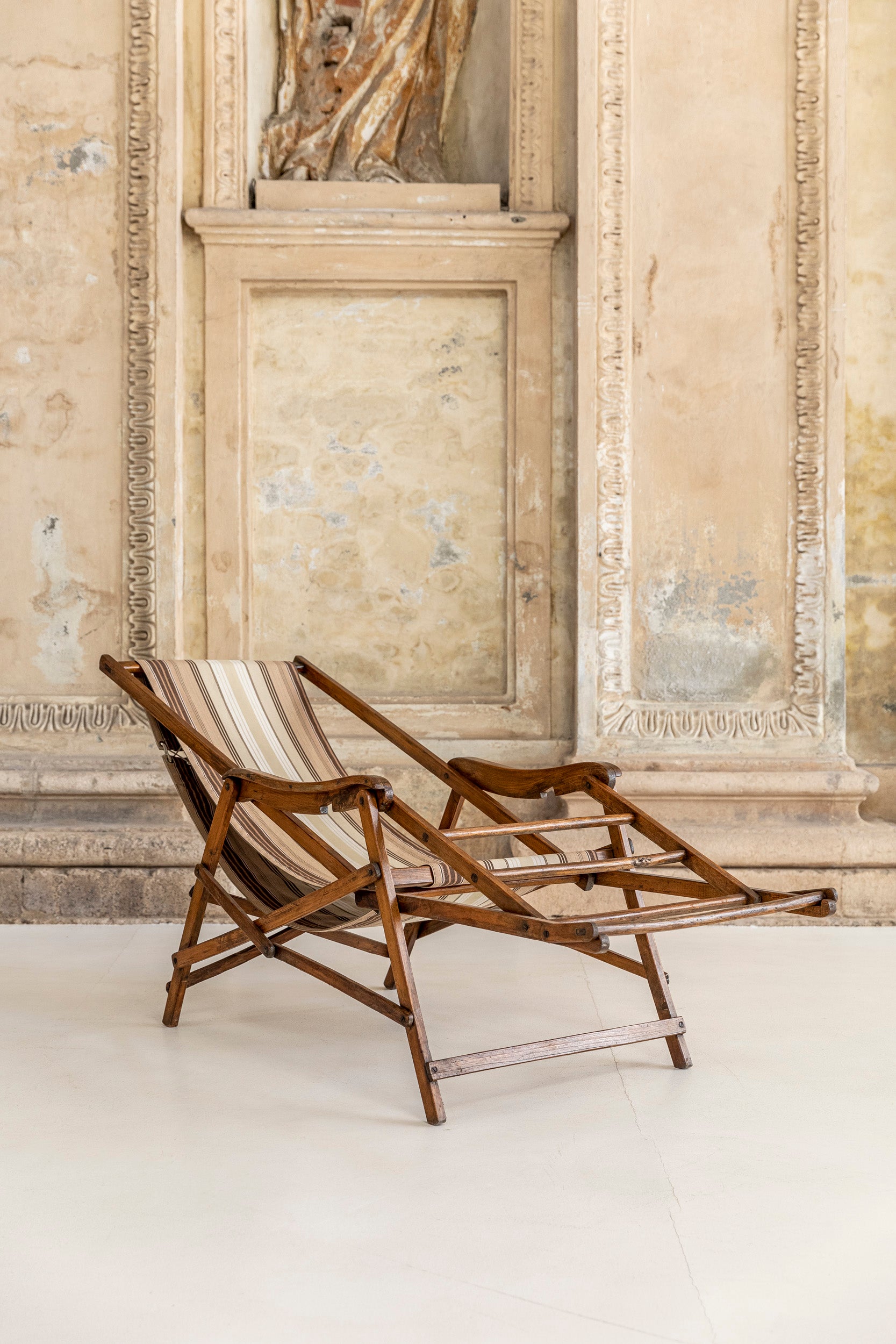 Deckchair in solid wood and fabric. Seating made with a solid walnut structure finely worked and original fabric. The backrest can be reclined and the footrest can be adapted in different position. 
Italy, 1930 circa.