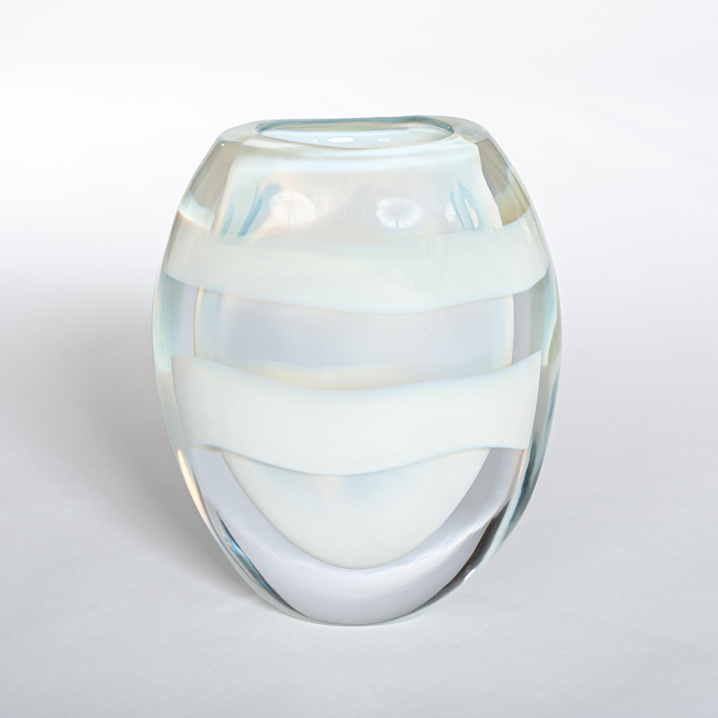 Modern Italian opalescent colored Murano glass vase signed by Pino Signoretto.
A transparent glass object made out of thick glass layers (total 2.5cm) shaped like eggs made in Sommerso Technique with two white circular color stripes.
Hot glass