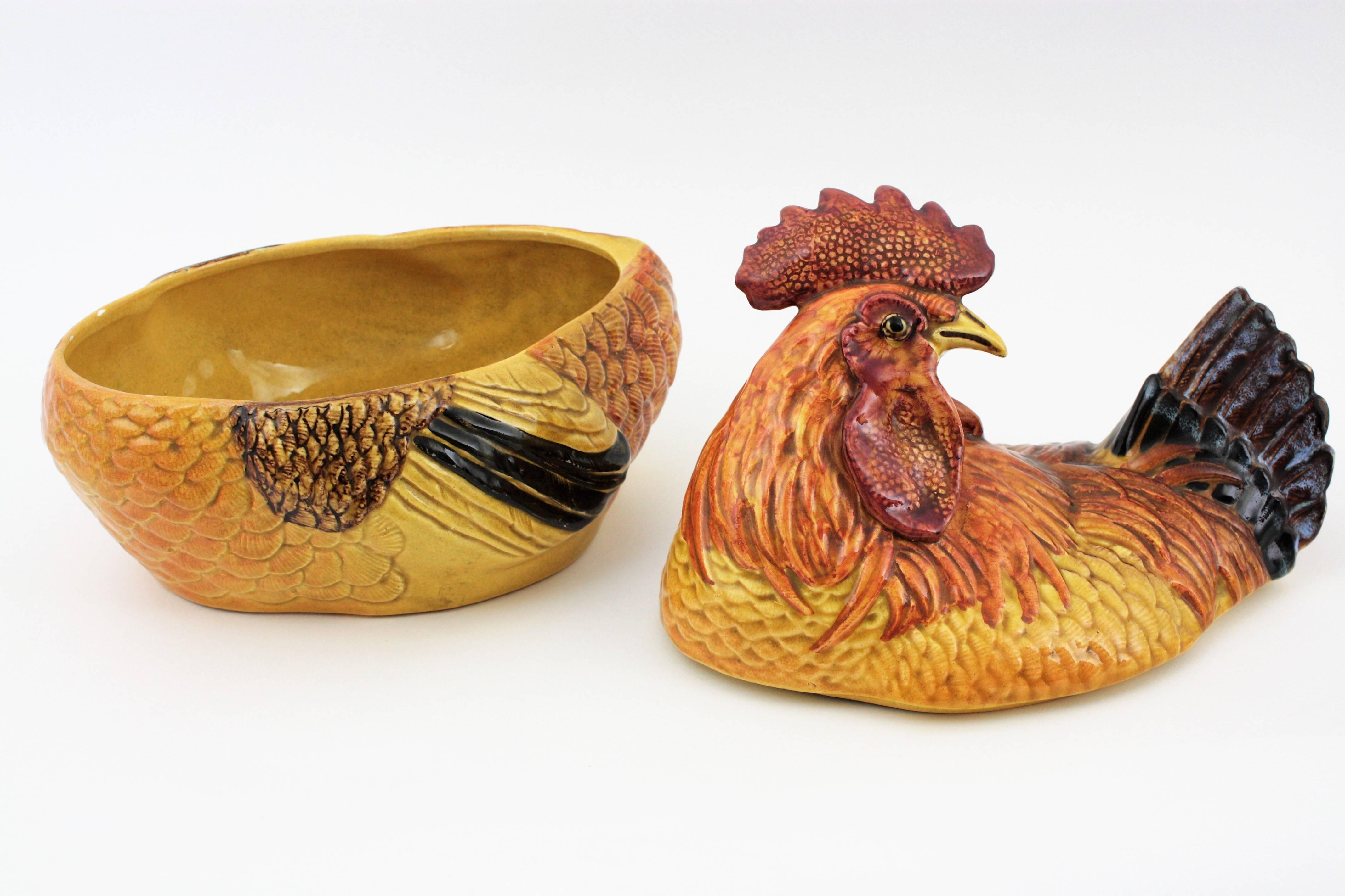 Eye-catching colorful hand painted glazed ceramic rooster shaped large tureen. Italy, 1950s.
The largest size in this kind of tureens or egg containers. 
This amazing and colorful hand painted glazed ceramic hen tureen in yellow, orange and red