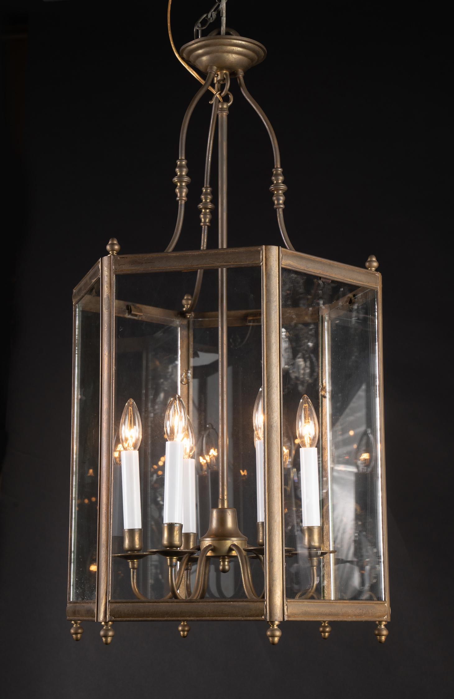 This classic Louis XVI style hexagonal hanging lantern is made of bronze and paneled glass. The piece is Italian and dates back to the mid 20th century. The design is both classic and timeless.



