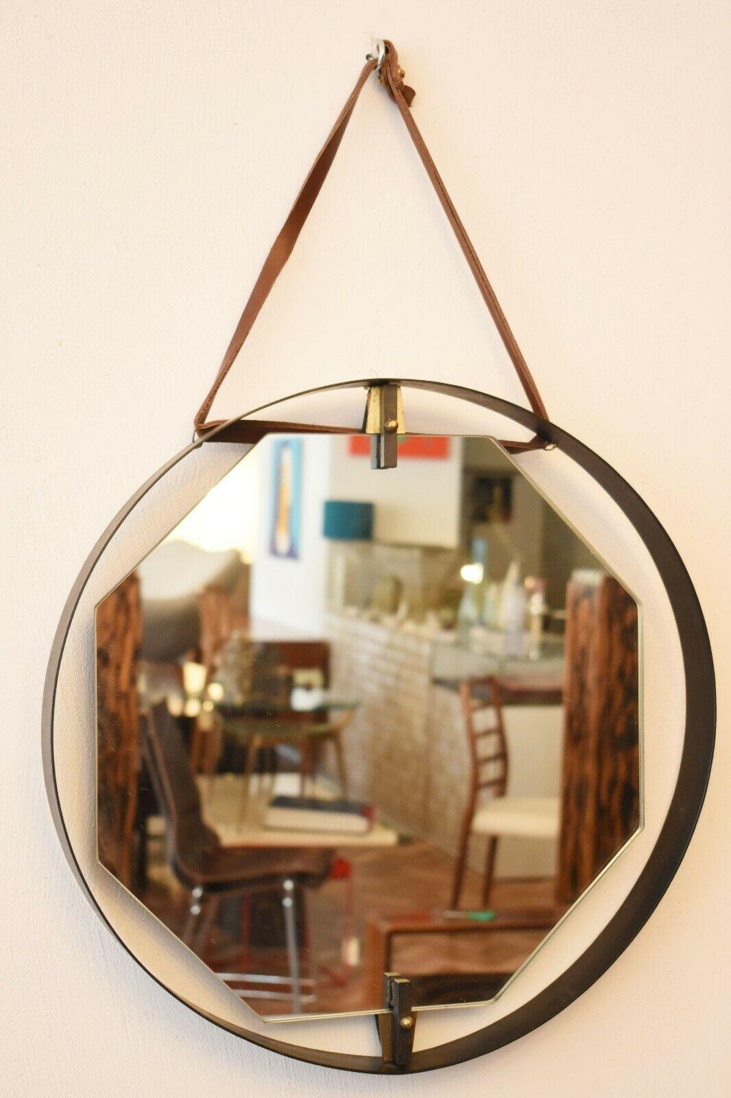 Rare and unusual Italian hexagonal mirror with circular brass frame, suspended by a leather strap.