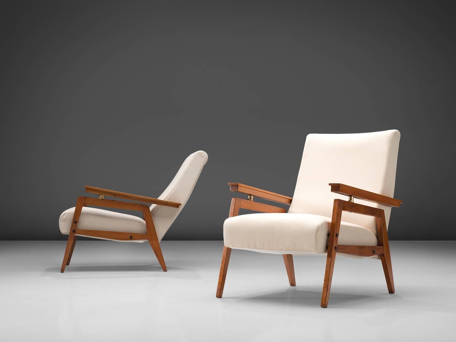 Italian lounge chairs, white fabric, stained oak, Italy, circa 1950.

This set of two elegant armchairs in off-white fabric and oak are made in Italy. The high tapered wooden legs provide an open look in combination with the L-shaped seating.