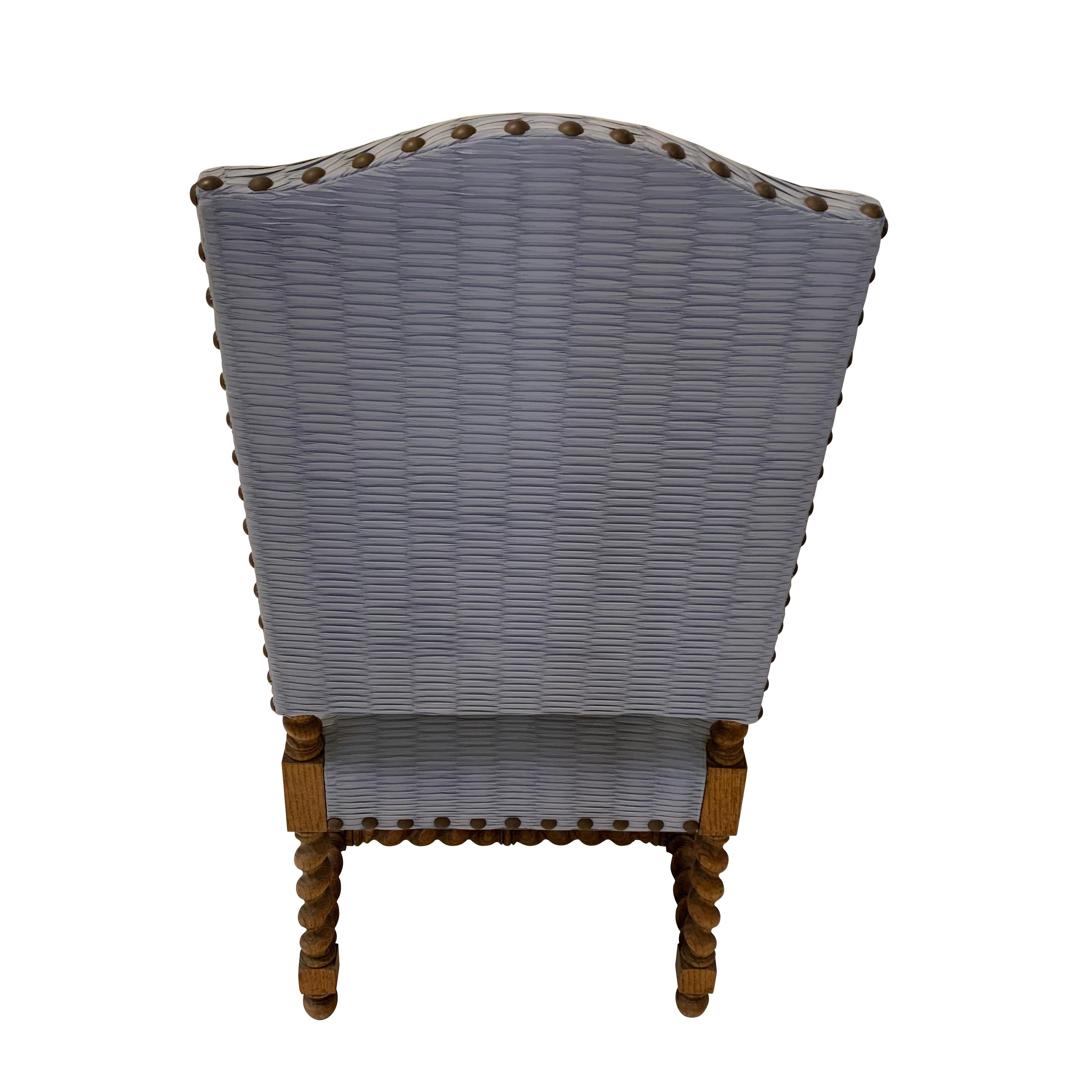 1930s Italian oak high back armchair with curved arms.
The arms are decoratively carved.
Stretchers are spiral.
The chair has been reupholstered in textured blue poly-rayon.
   