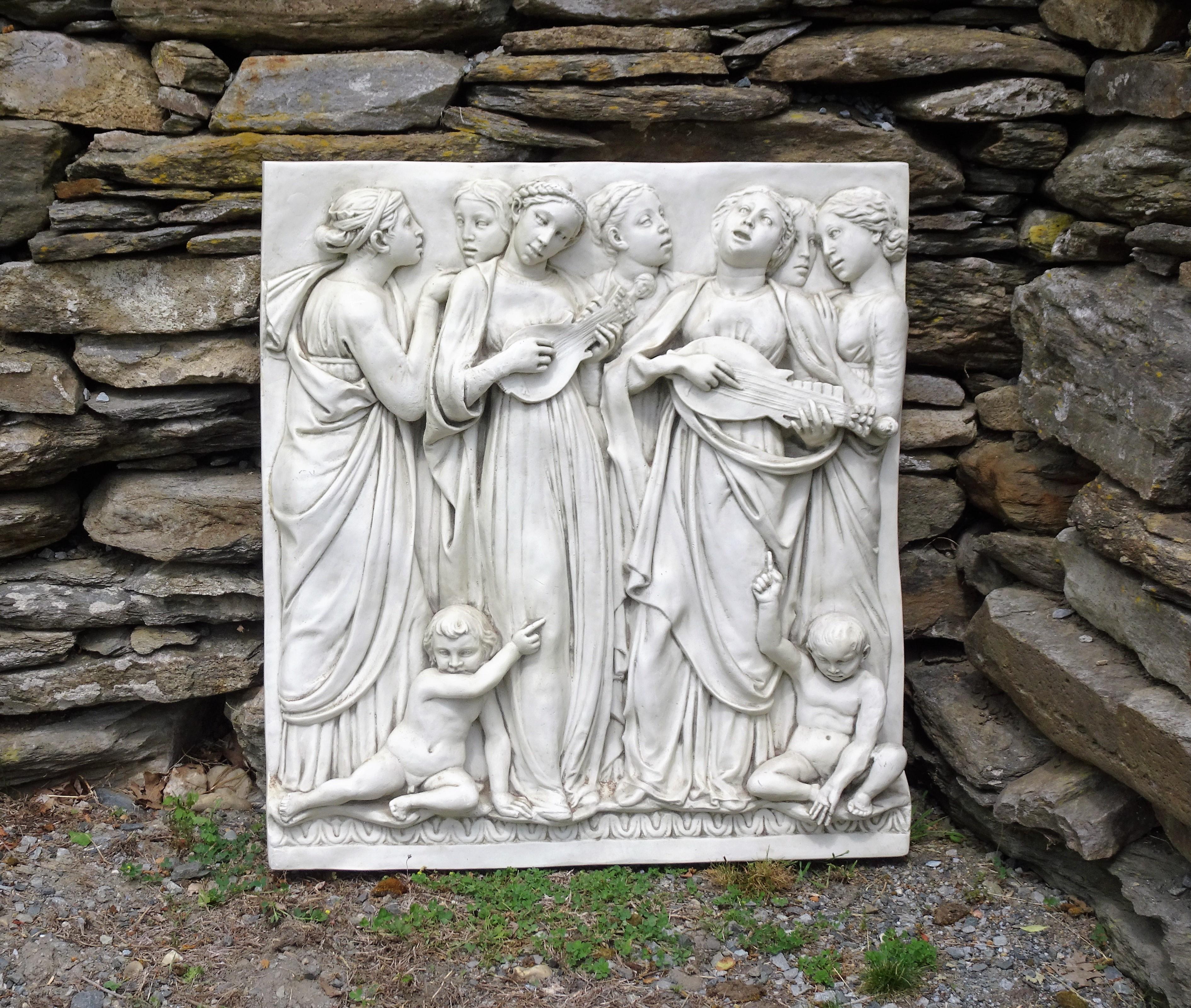 This is a large, high-relief wall hanging in midcentury Italian fiberglass. It is in the neoclassical style and depicts seven of the mortal daughters of Jupiter. They are singing, while two of them play stringed instruments, and they are standing