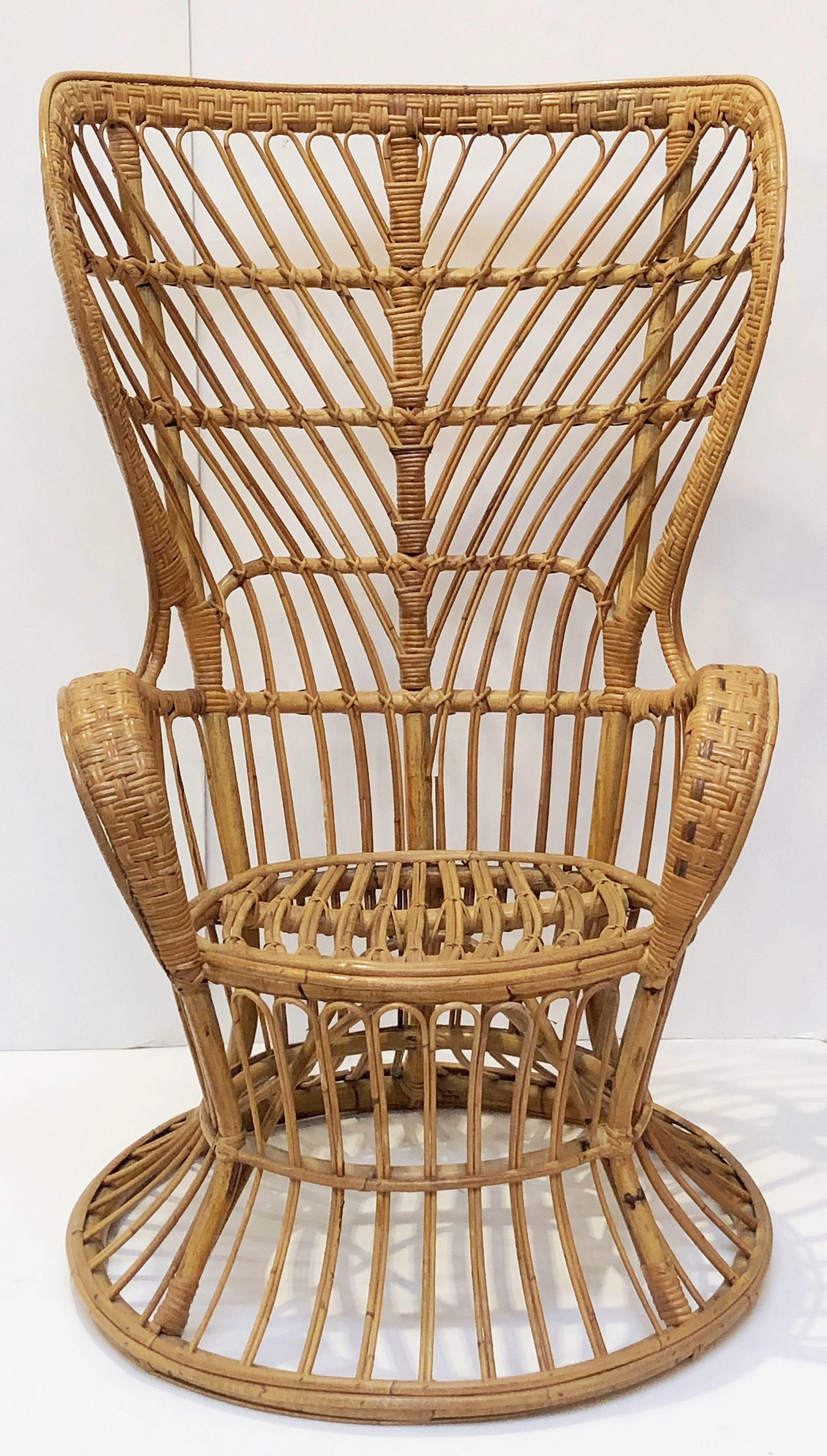 A fine Italian handcrafted mid-century high back rattan and bamboo armchair or lounge chair of the style originally designed for the cruise ship Conte Biancamano by Lio Carminati and Gio Ponti in the 1950s and manufactured by Pierantonio Bonacina.