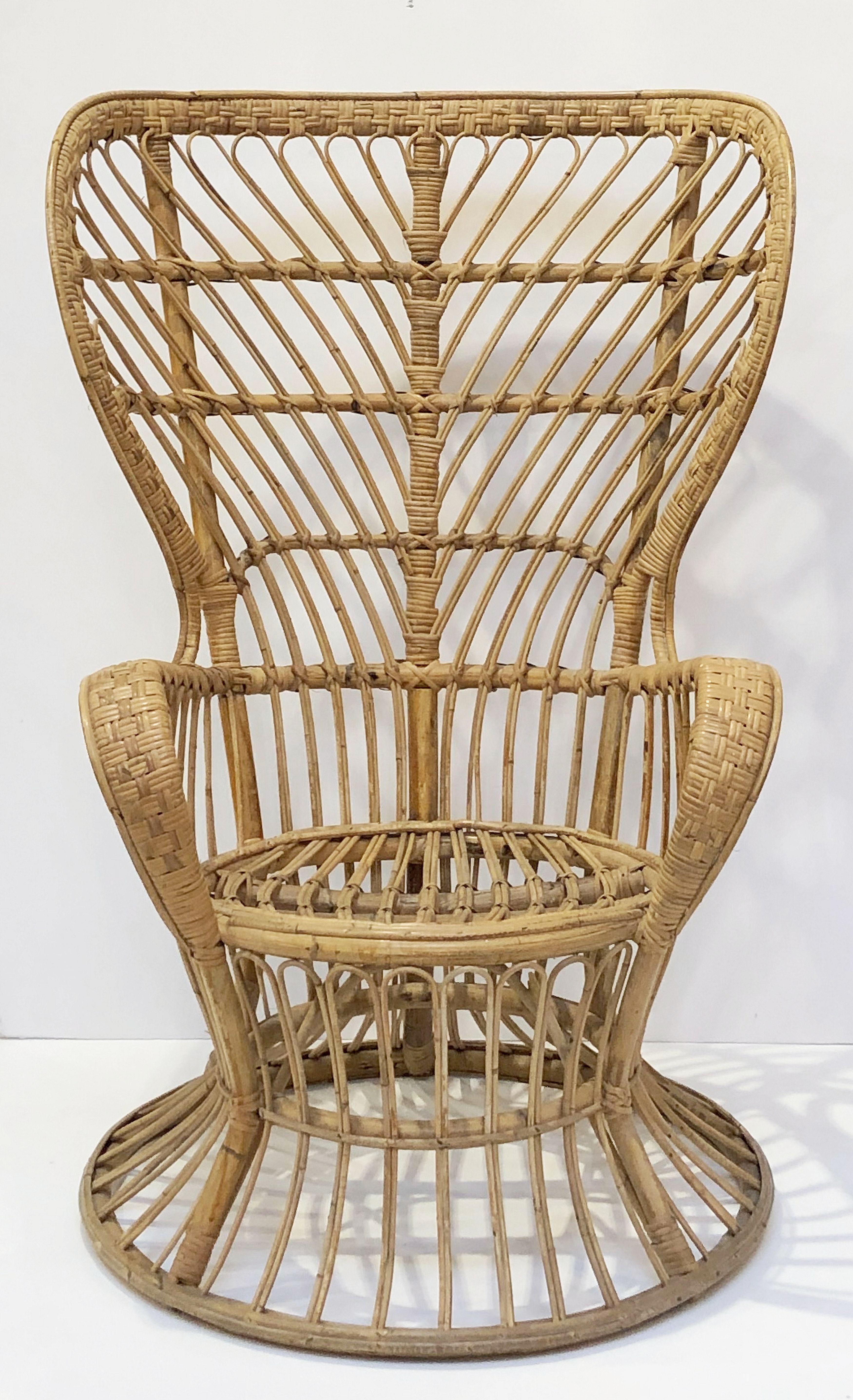 A fine Italian handcrafted mid-century high back bamboo and rattan armchair or lounge chair of the style originally designed for the cruise ship Conte Biancamano by Lio Carminati and Gio Ponti in the 1950s and manufactured by Pierantonio Bonacina.